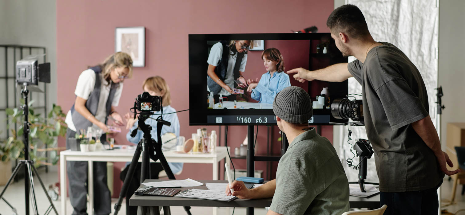 A group of four production staff shooting in a film studio
