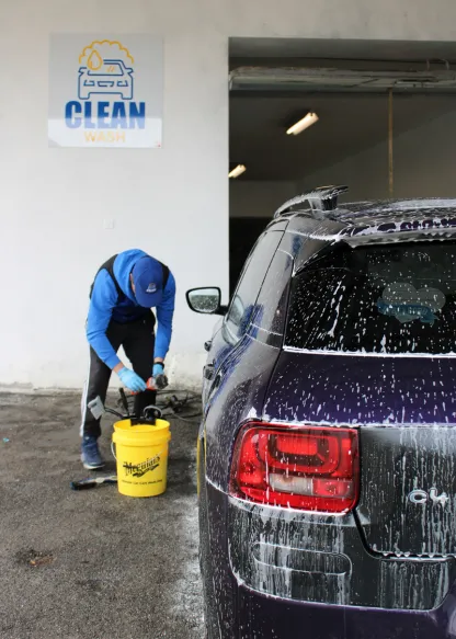 One of our cleanwashauto employees cleaning a car