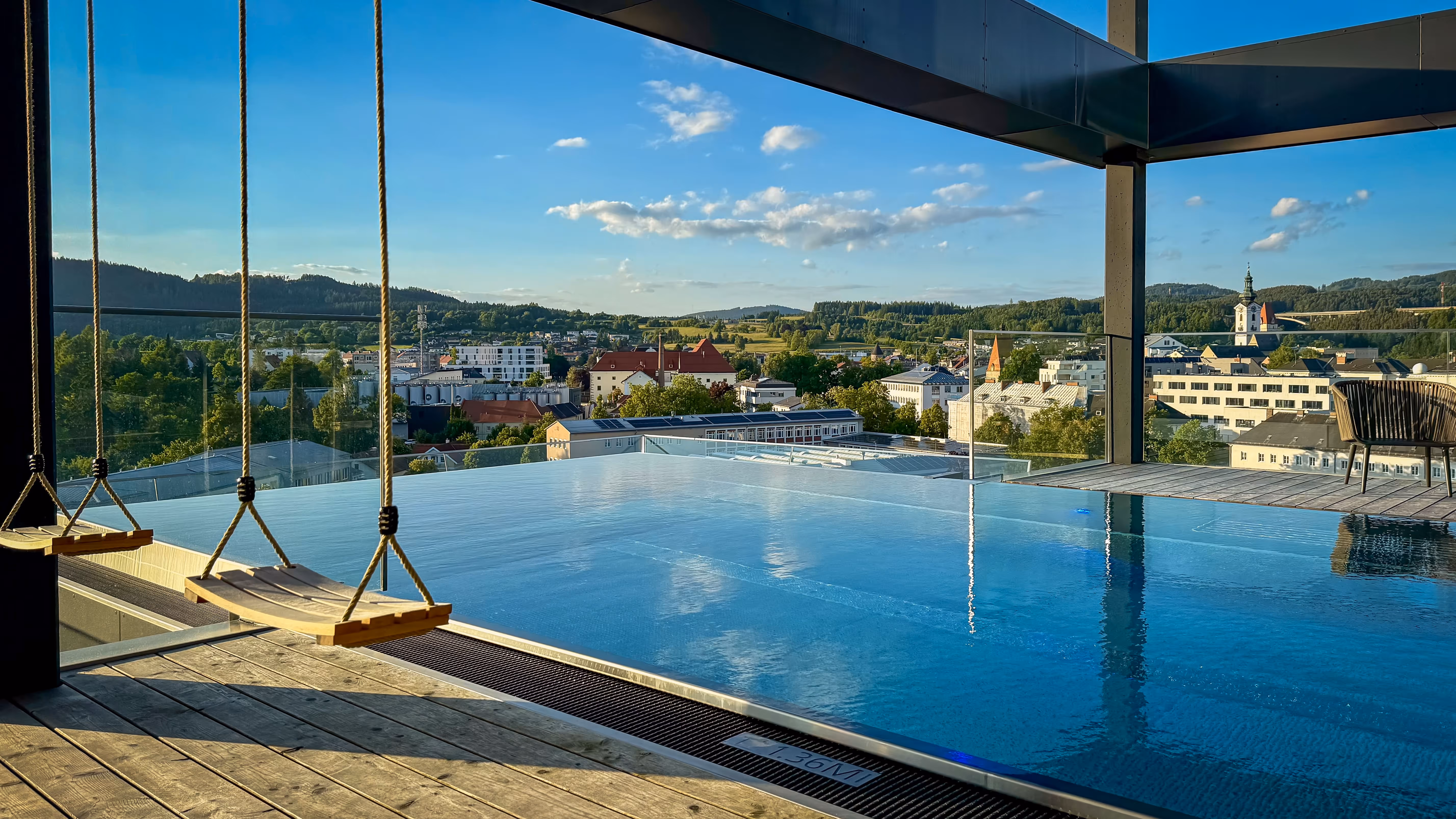 Rooftop pool with swings and mountain view