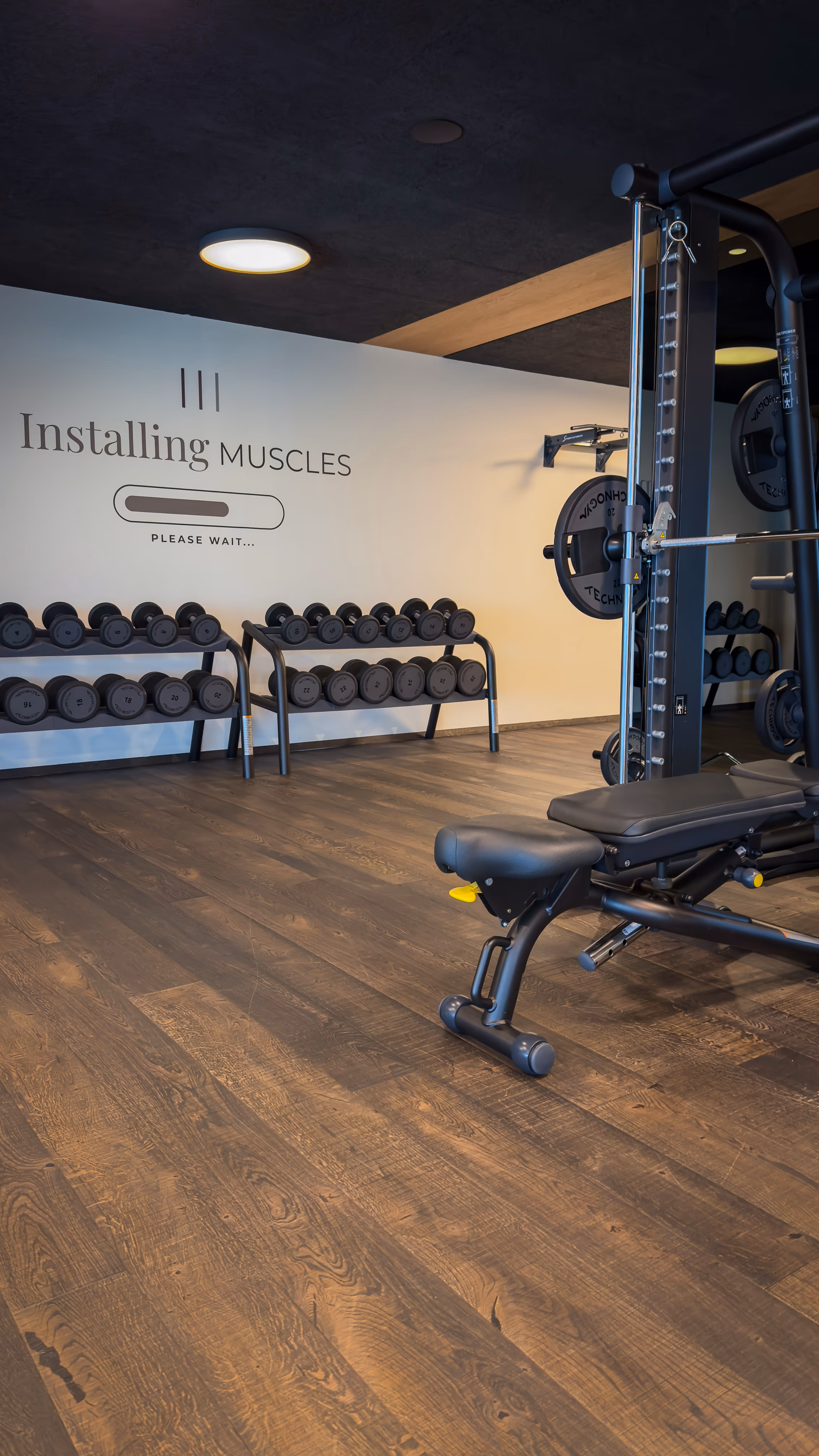 Hotel gym with a power rack and heavy weights