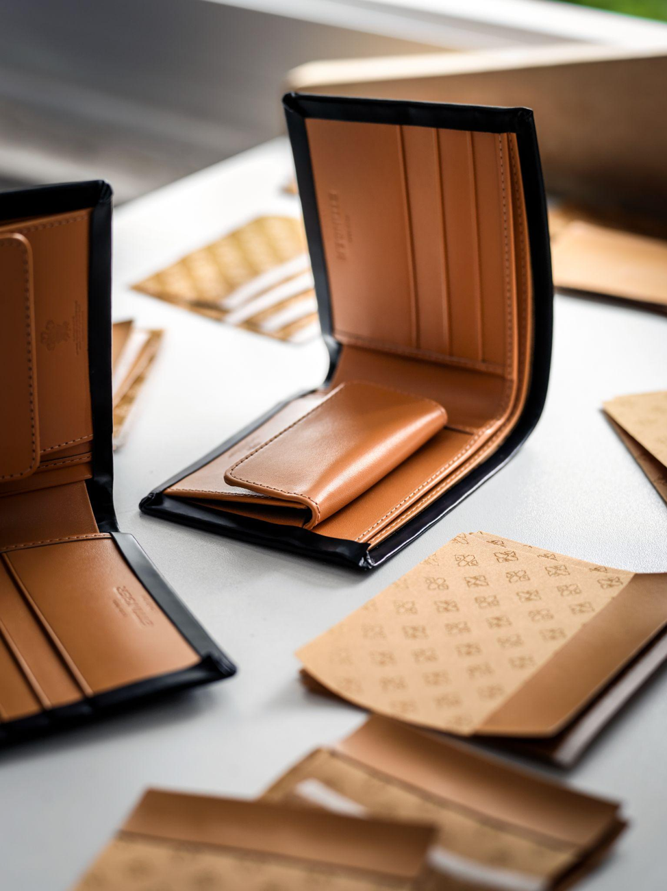 Ettinger craftsman hand-stitching a Bridle Hide leather wallet
