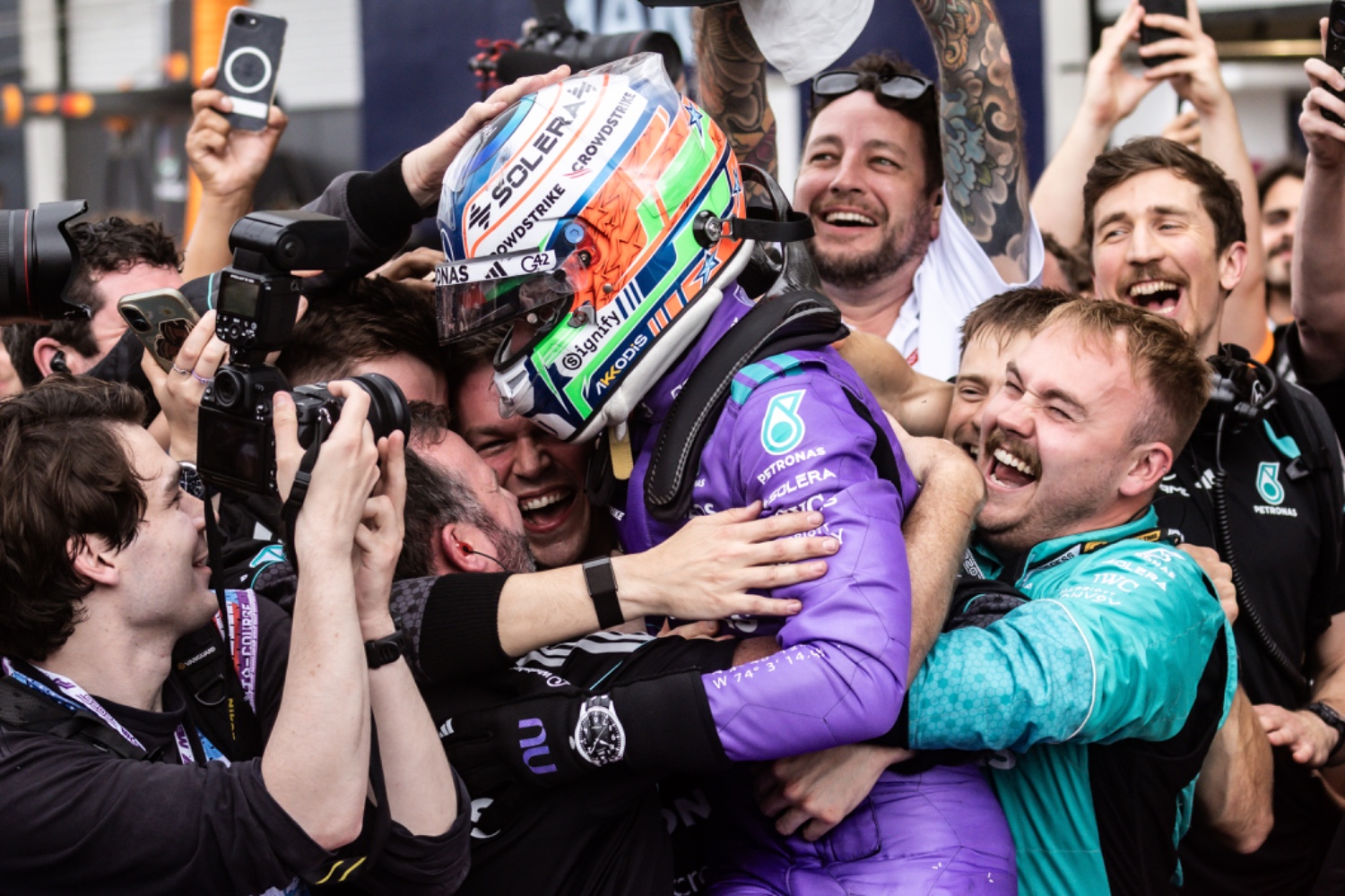 Kimi Antonelli holding the trophy on the podium after winning the 2026 Miami Grand Prix, Living Sports