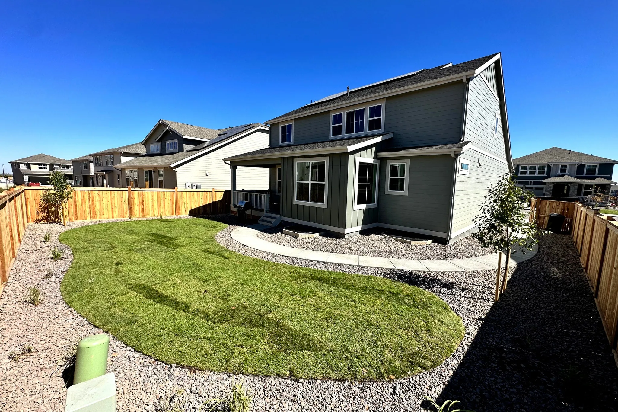 New backyard landscaping with fresh sod and decorative rock