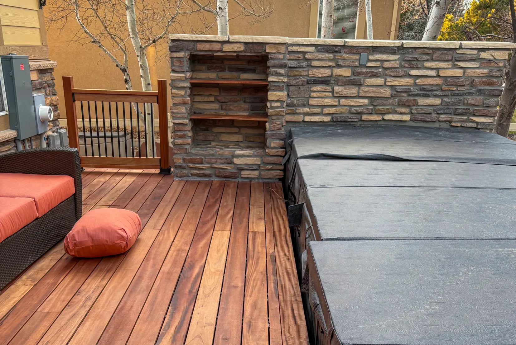 Custom wood deck with hot tub and stone outdoor living area