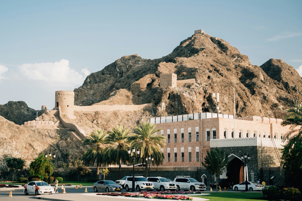 A historic fort in Muscat, Oman, set against rugged mountains