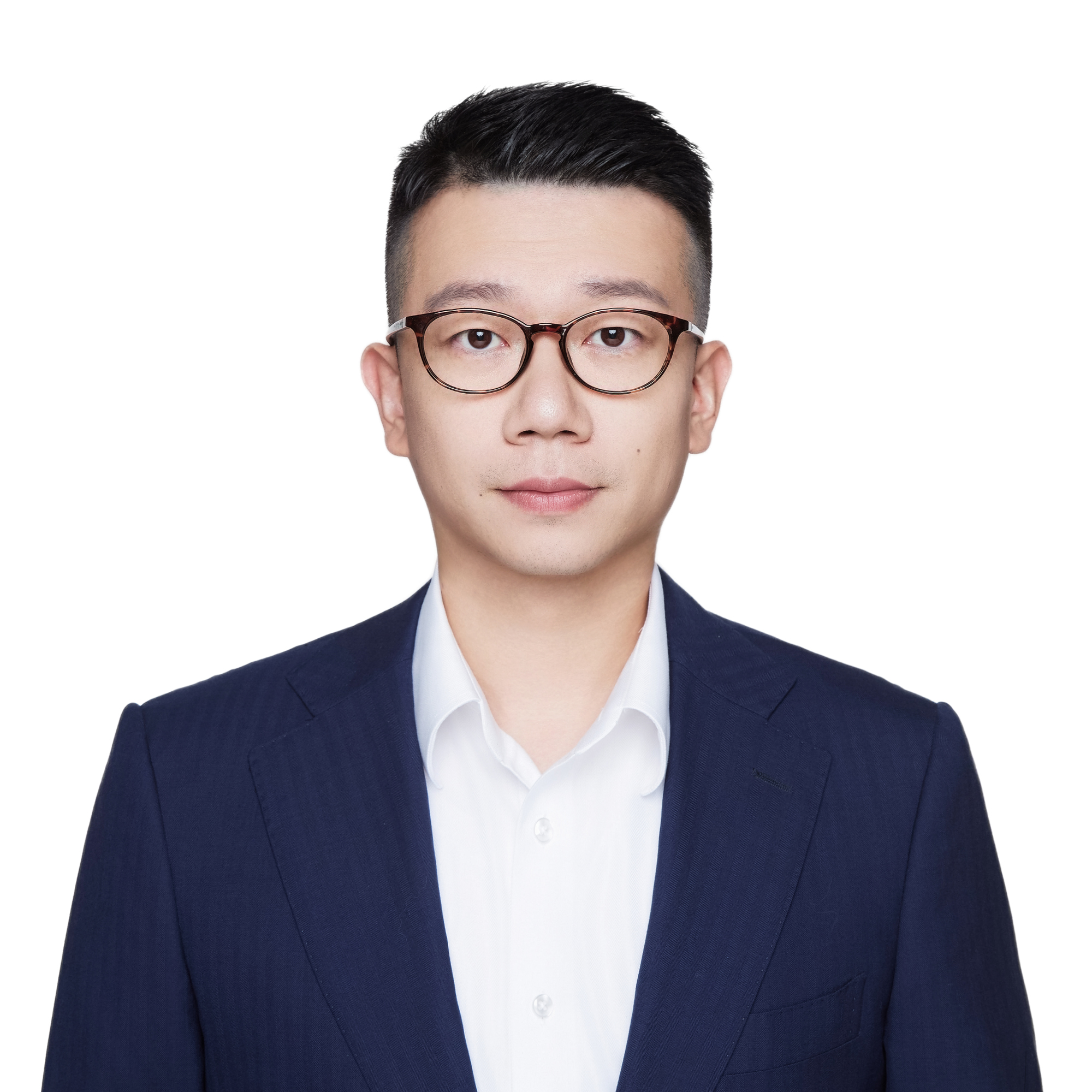 Man with short black hair and glasses wearing a dark blue suit jacket and white shirt.