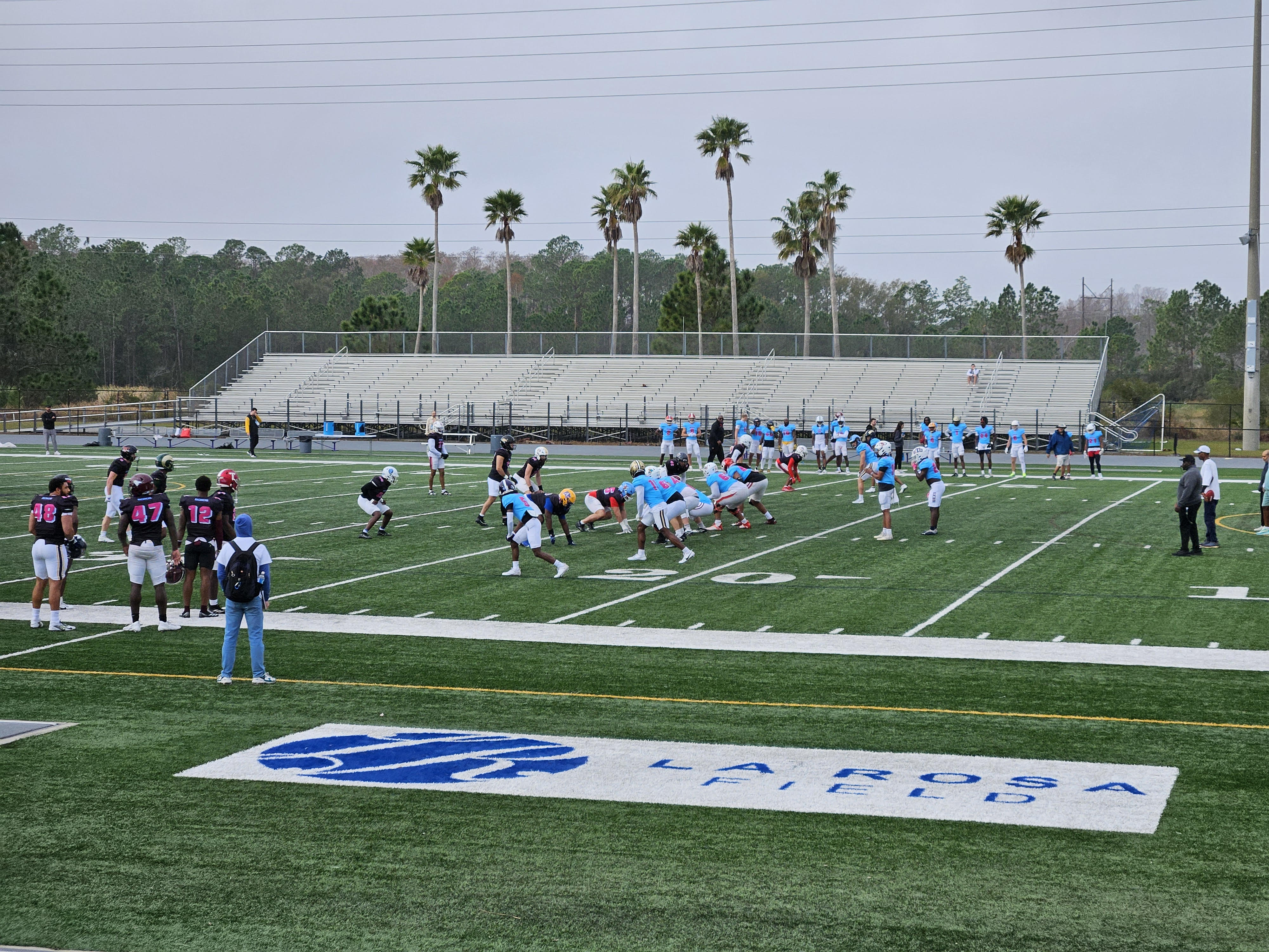 Football field with two teams practicing