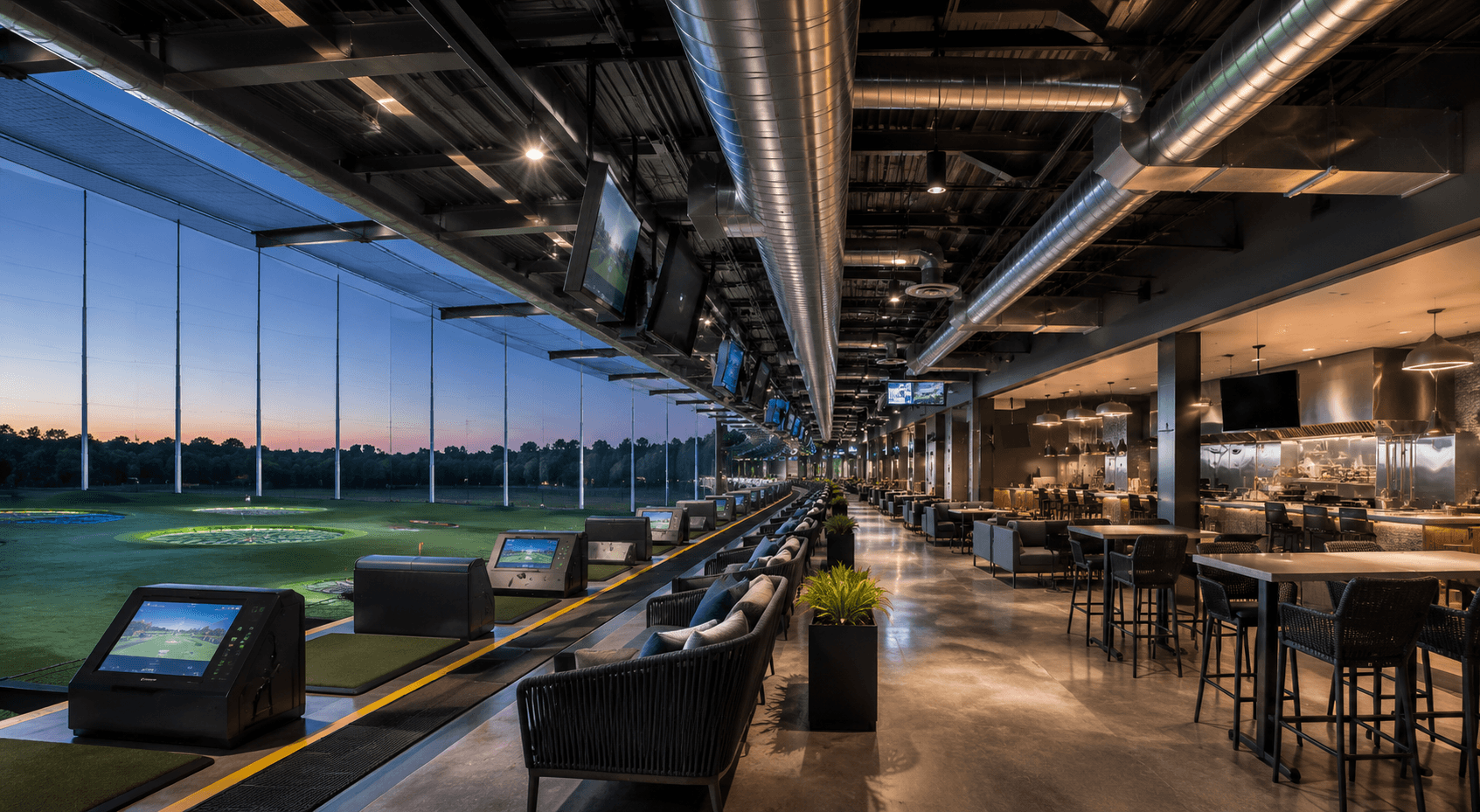Modern golf entertainment venue at dusk