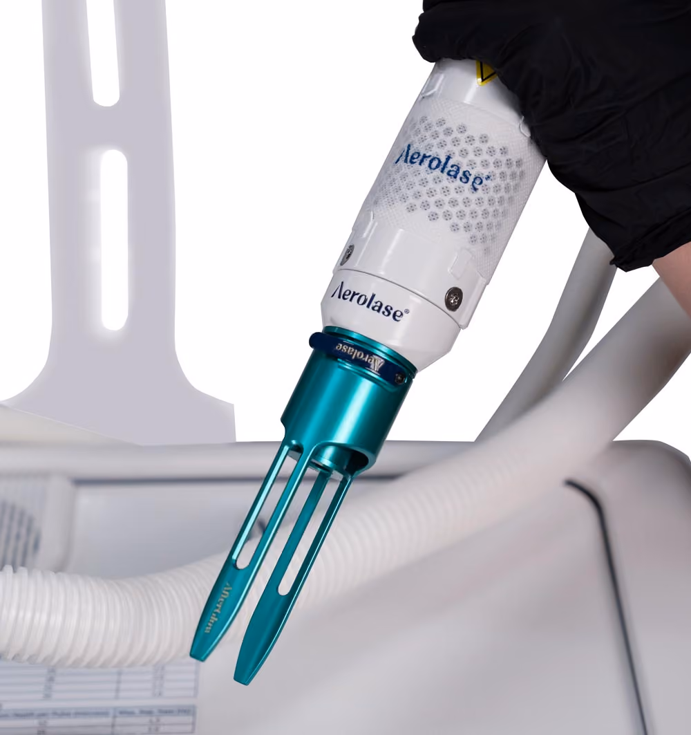 hand holding the Aerolase Era handpiece with the AfterGlow lens attached.