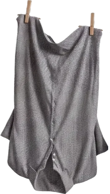 Gray, long-sleeved blouse hanging on a clothesline secured by two wooden clothespins, made of lightweight fabric with a subtle pattern and buttons down the front.
