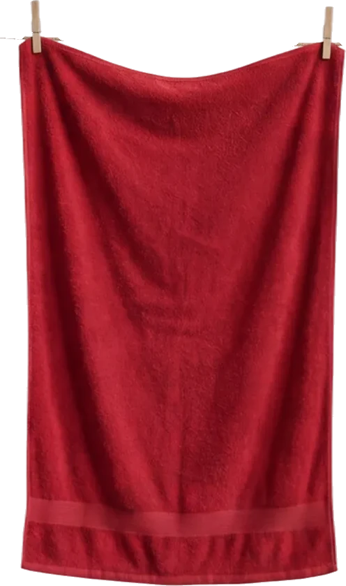 Red towel hanging from a clothesline with two wooden clothespins on a black background.