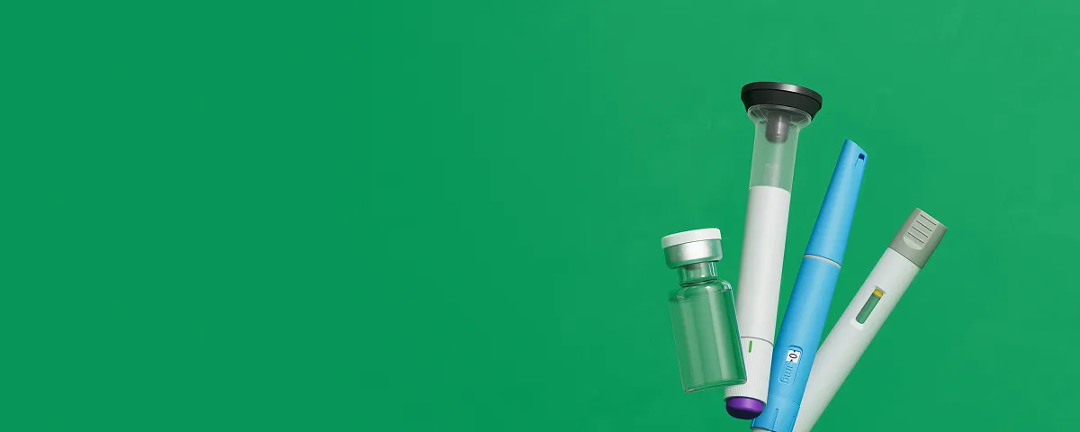 Various GLP-1 injector pens and a glass medication vial.