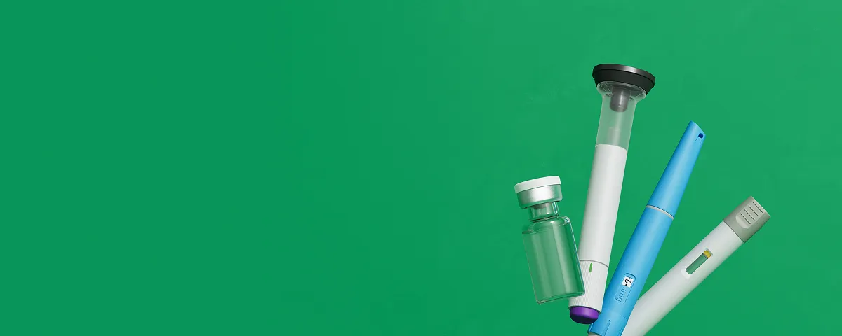 Various GLP-1 injector pens and a glass medication vial.