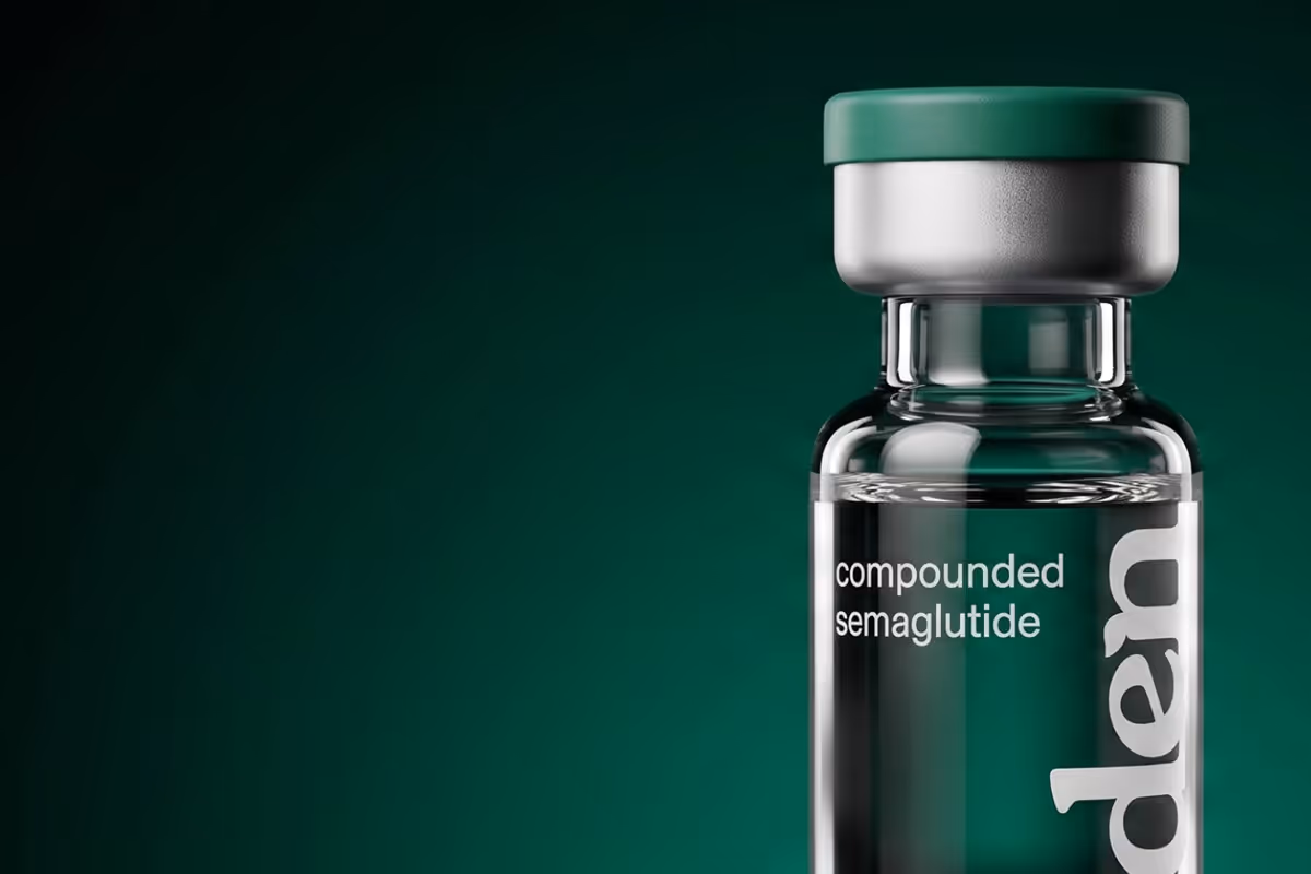 Glass vial with green cap labeled compounded semaglutide on a dark green background.