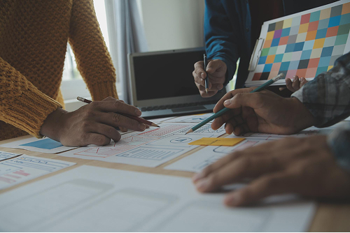 Team working at desk representing slow Webflow page development workflow