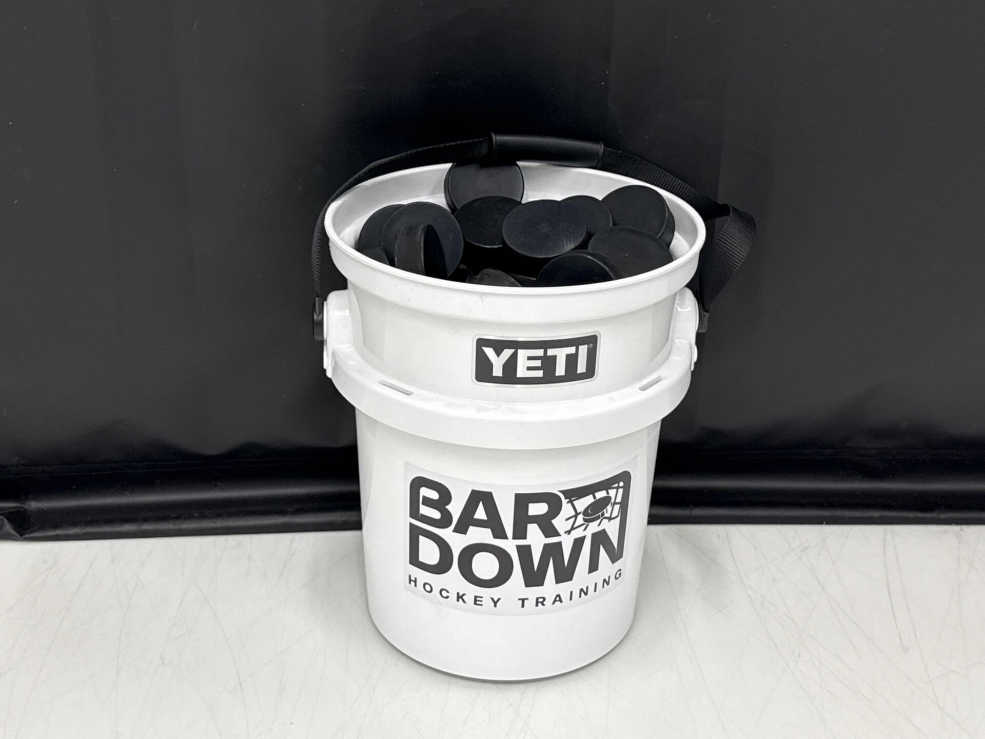 bucket of hockey pucks 