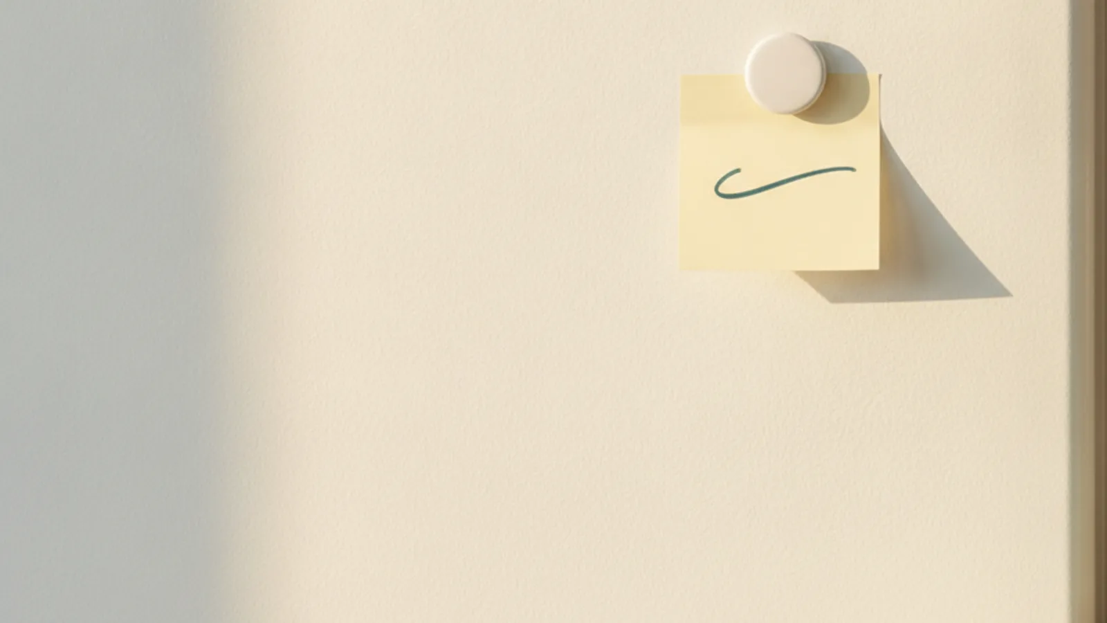 A single handwritten note stuck to a fridge door in soft morning light