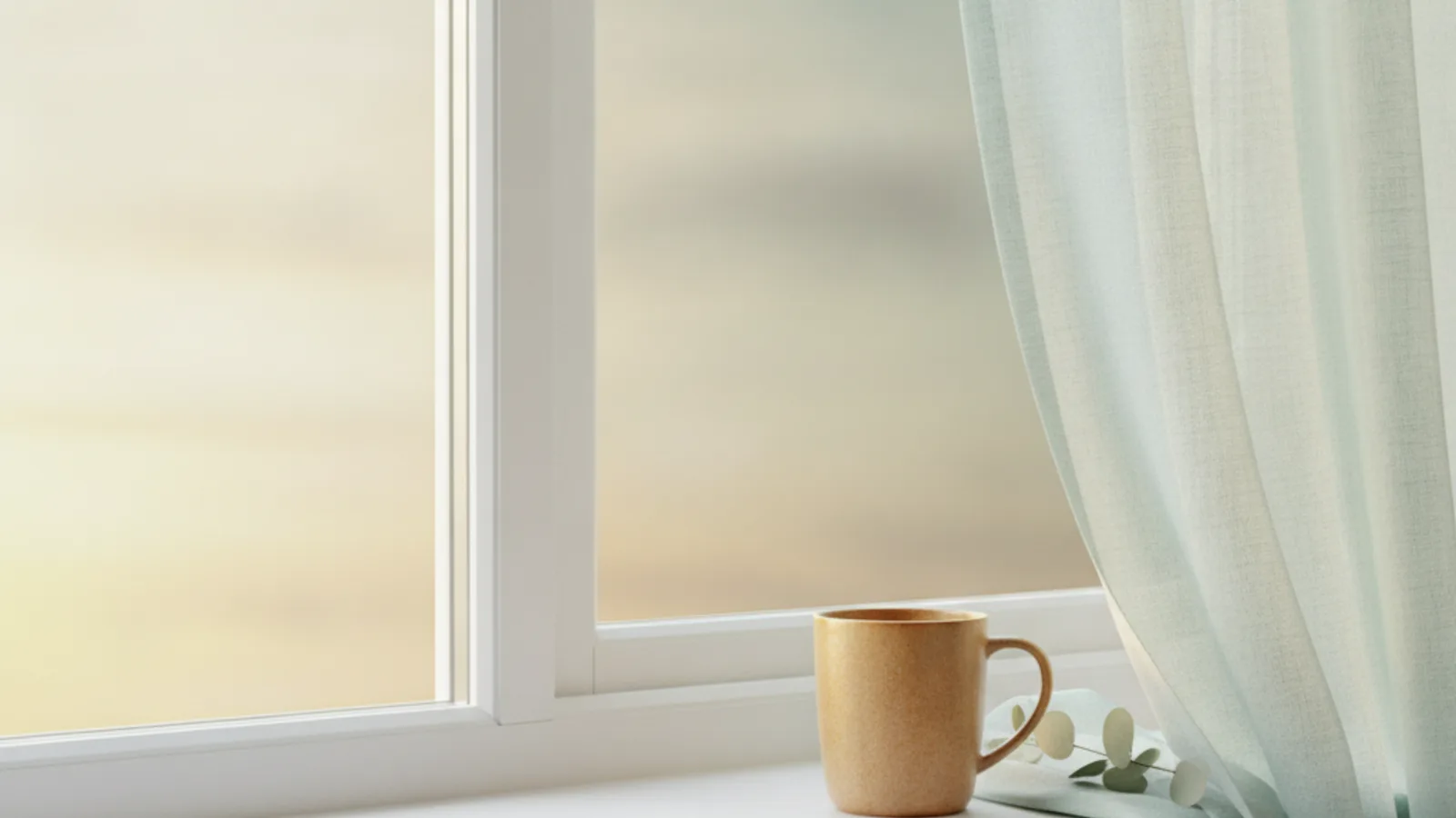 A cup by an open window at dusk on a Sunday evening