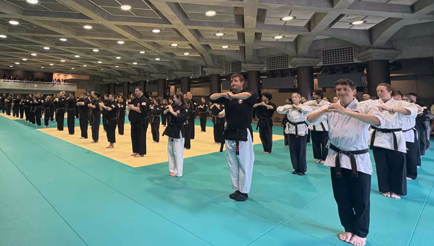 Karate students lined up at attention, ready to begin their test at the Budokan.