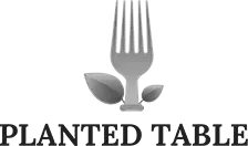 Logo of Planted Table featuring a fork with two leaves at the base above the text 'PLANTED TABLE'.