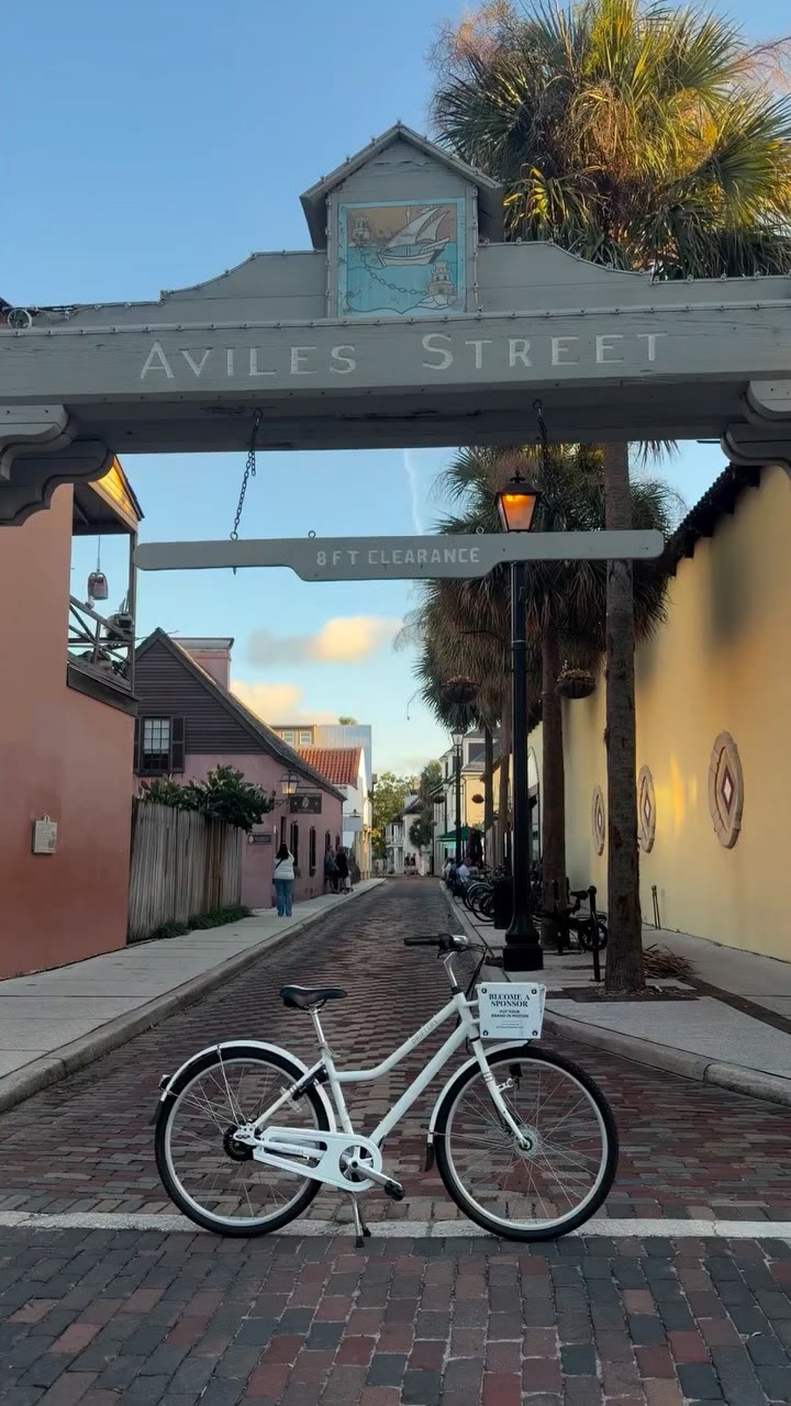 A Drifters city bike under the Aviles Street sign on a brick street