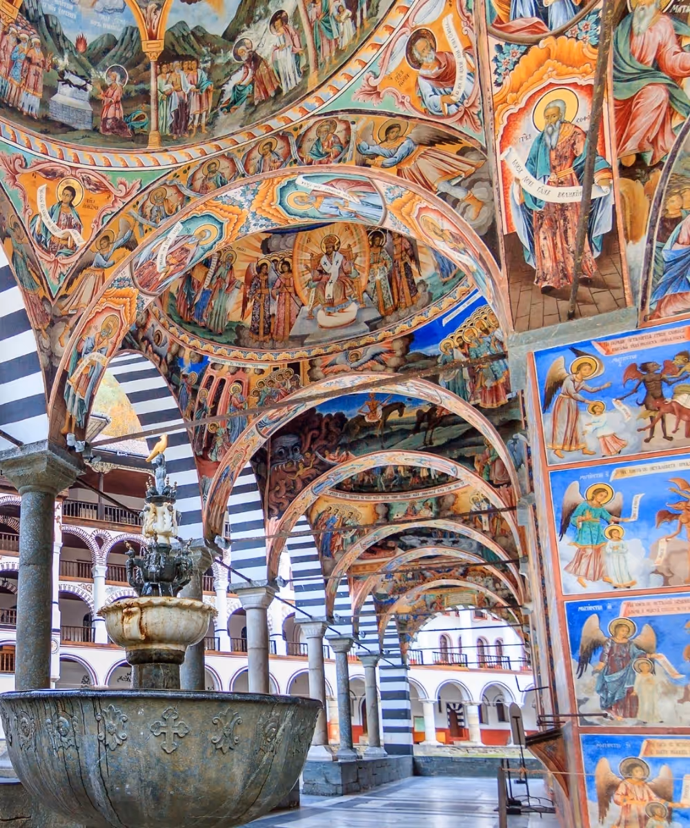 Beautiful religious frescoes painting the arches of the historic Rila Monastery in Bulgaria.