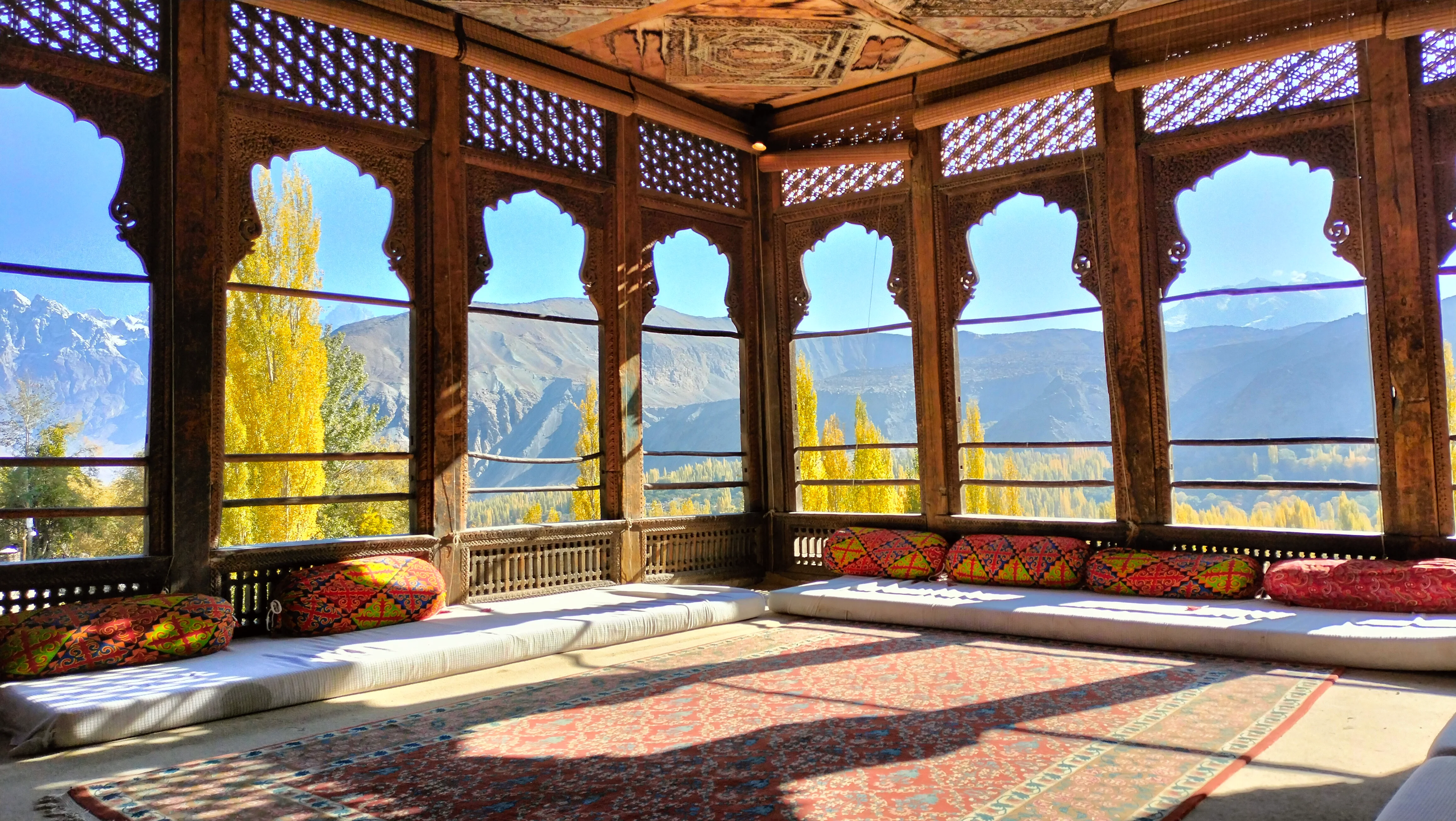 Inside Baltit Fort’s wooden sitting room with panoramic mountain views and traditional decor.
