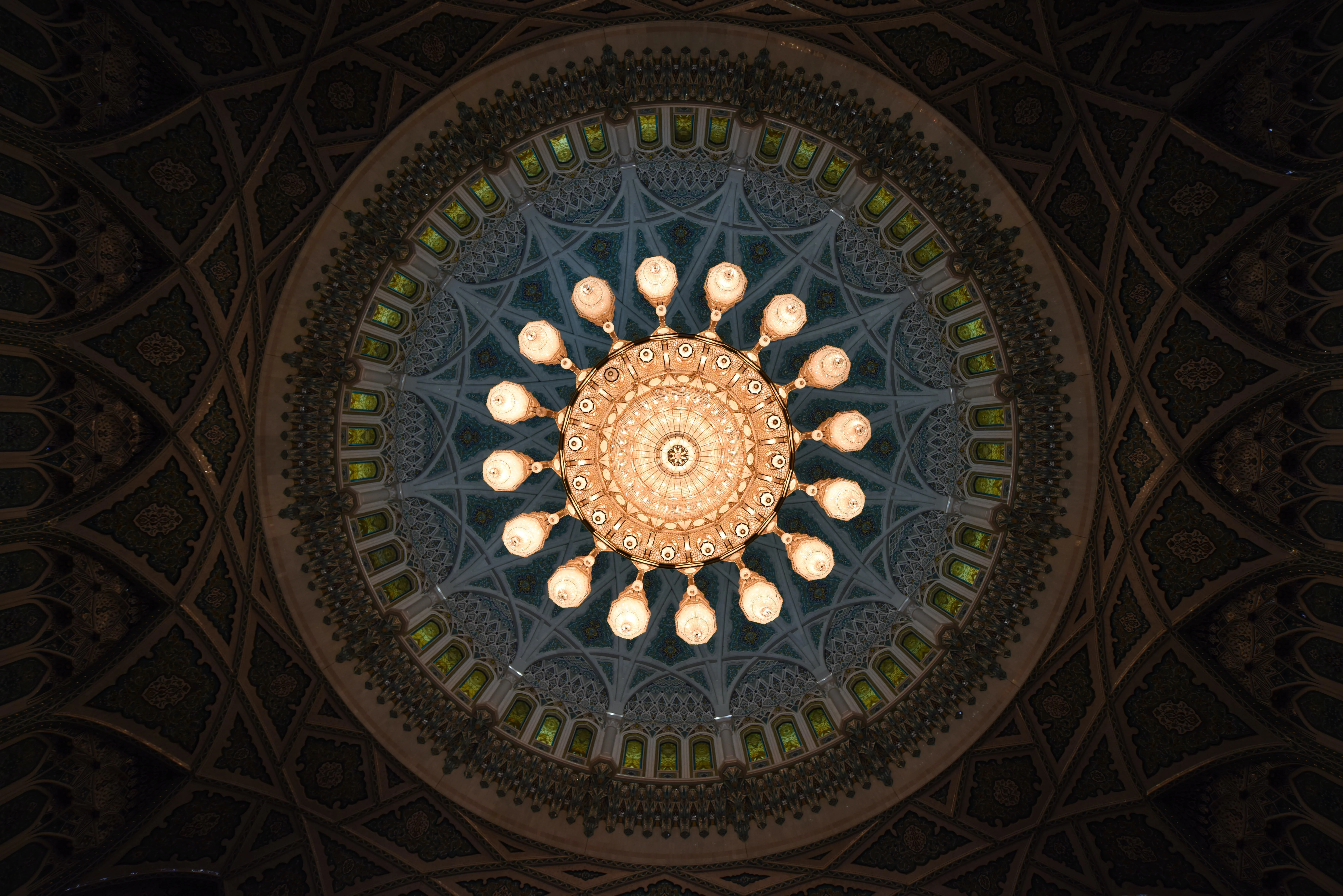 Ornate chandelier inside Sultan Qaboos Grand Mosque seen during an Oman tour.