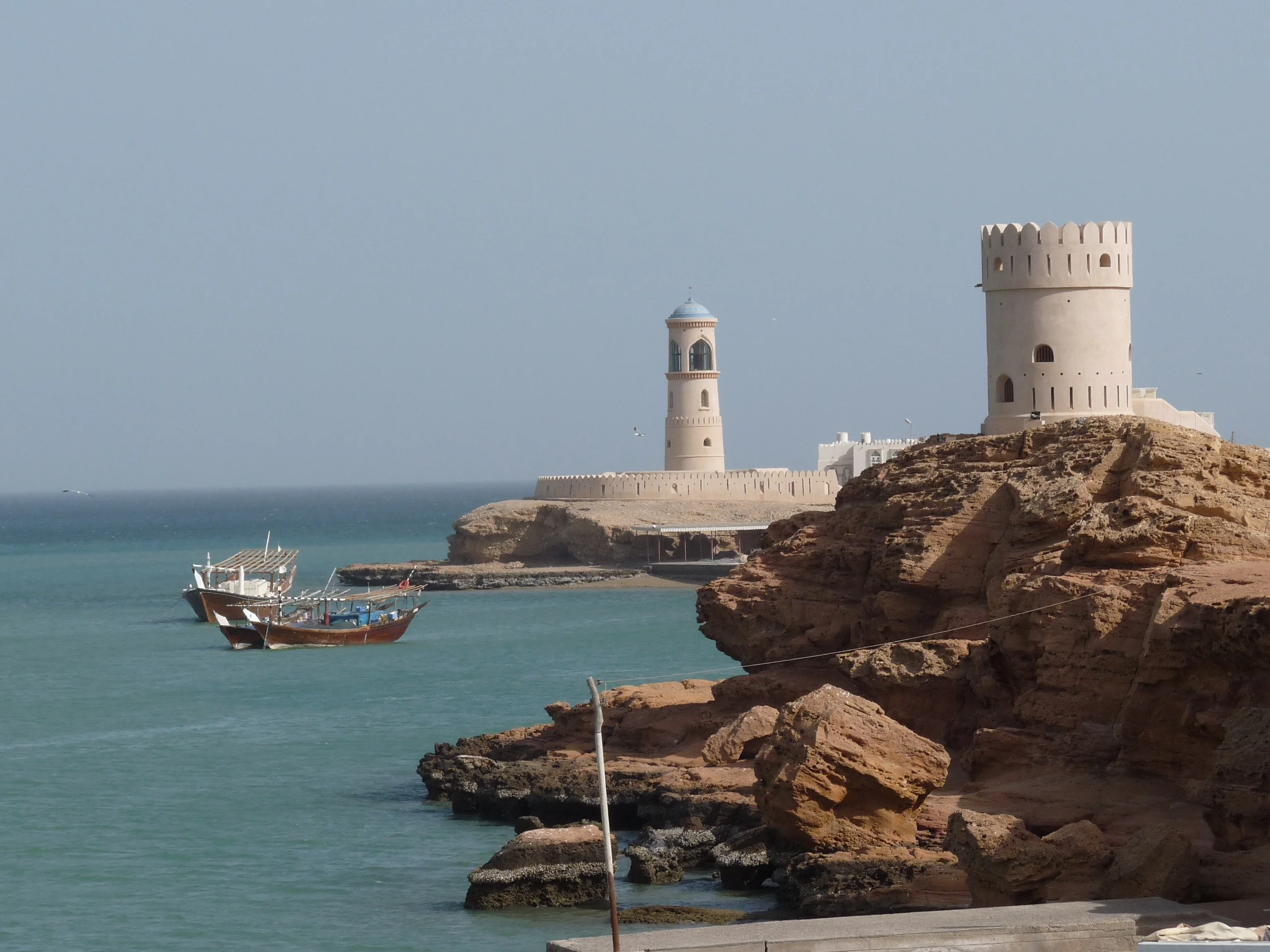 Watchtowers and dhows along the coast of Sur captured on an Oman tour.