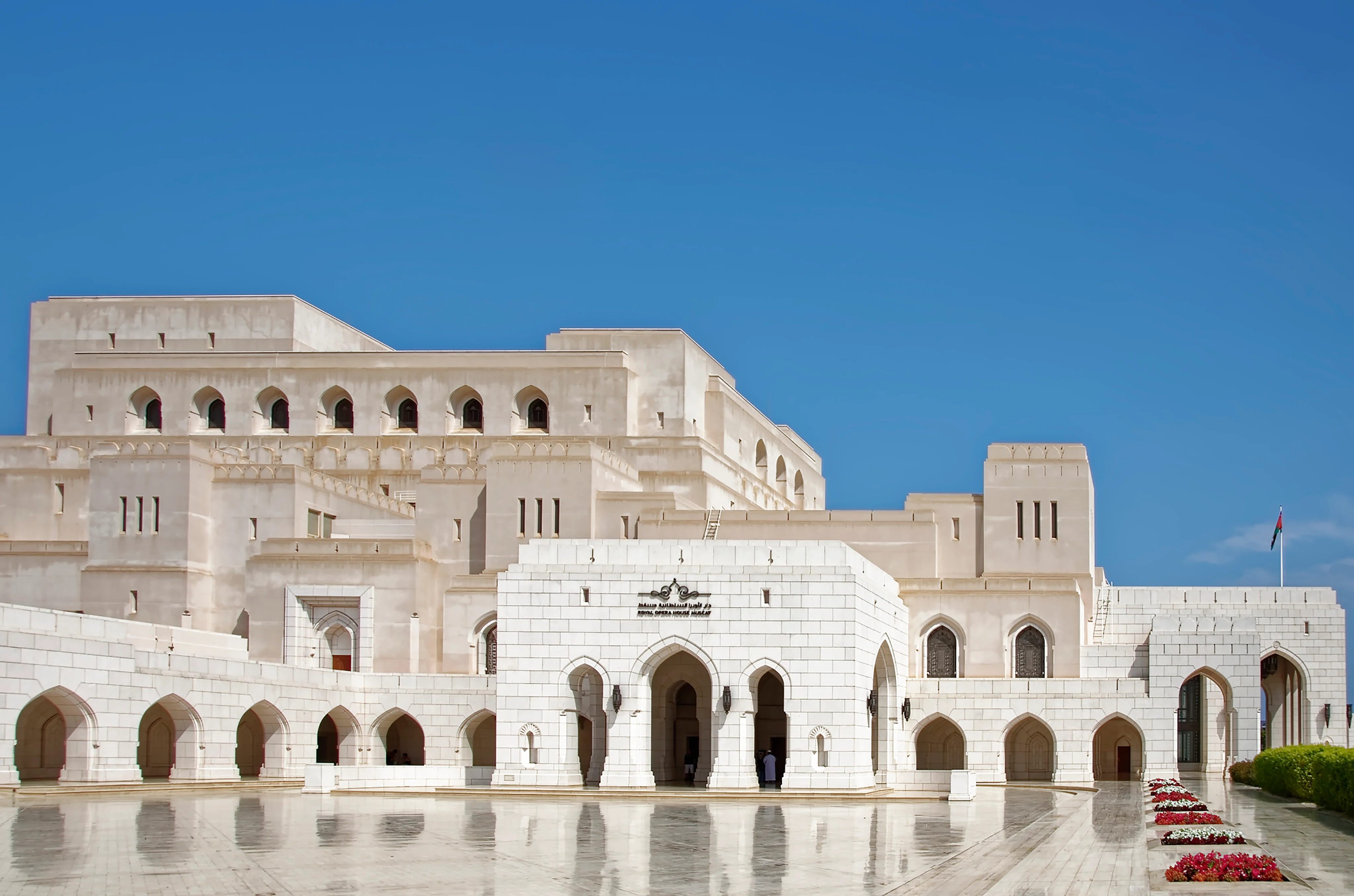 Royal Opera House Muscat front facade under clear blue skies on an Oman tour.