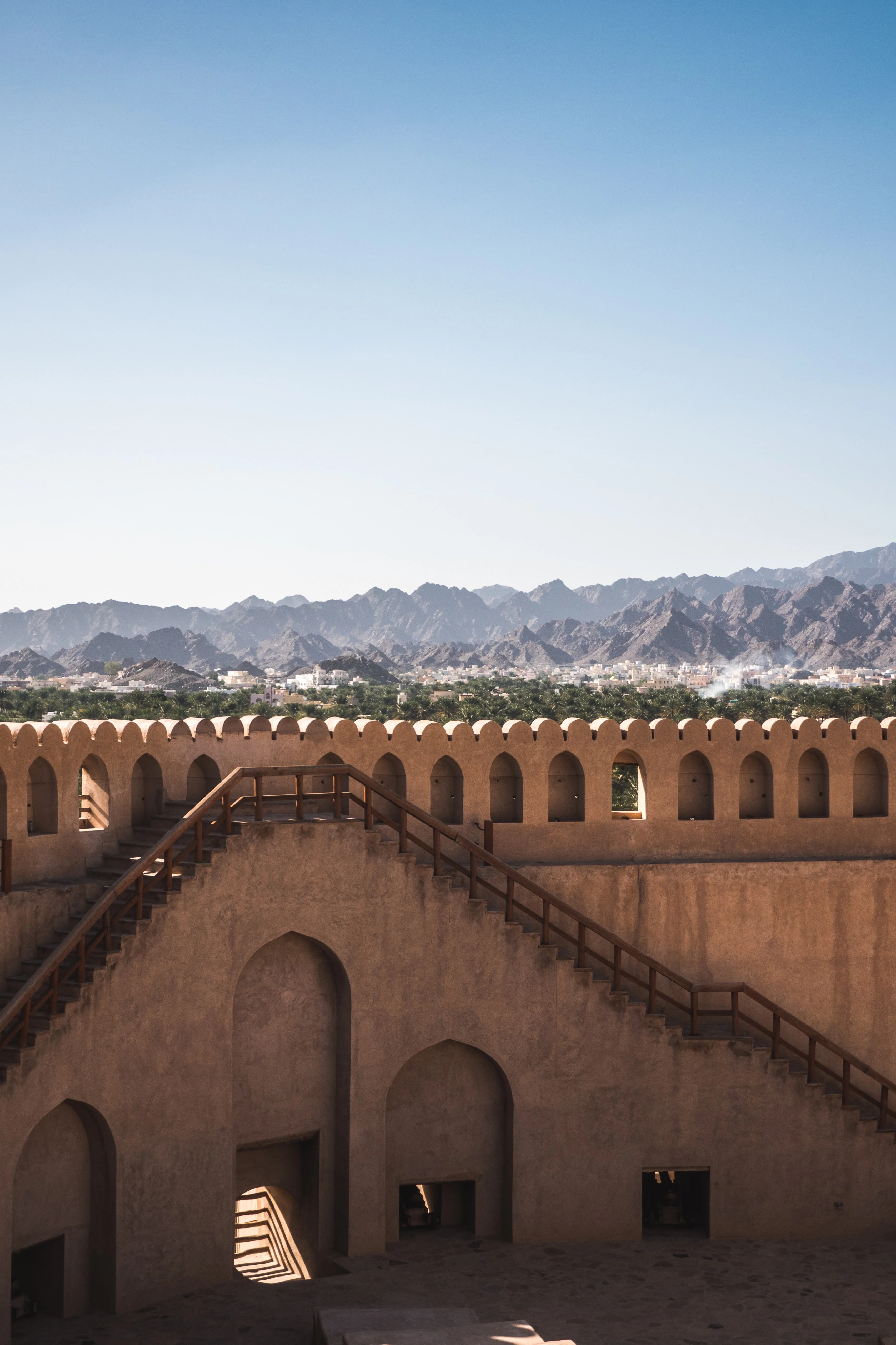 Mountain view from atop Nizwa Fort showcasing Oman tour landscape highlights.