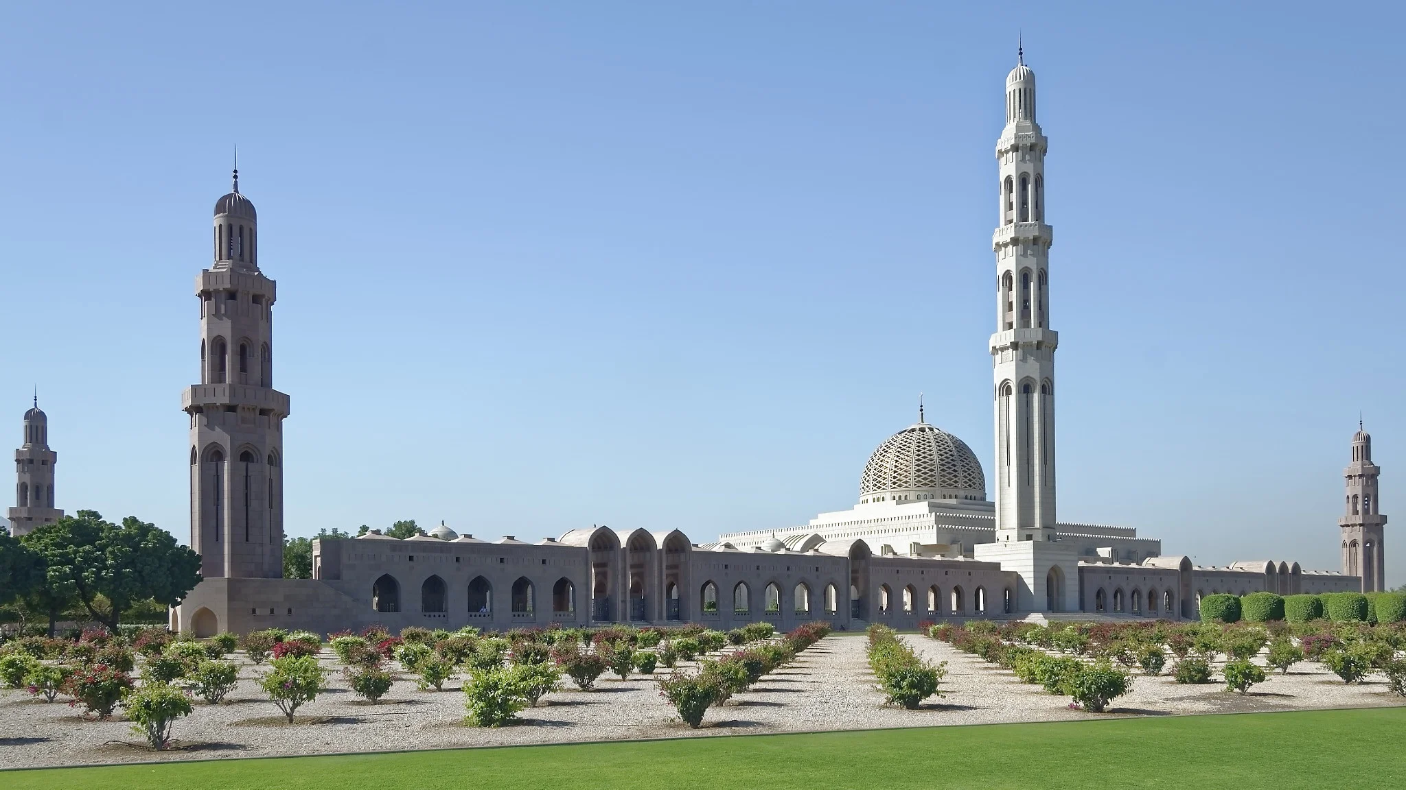 Sultan Qaboos Grand Mosque minarets and gardens on a guided Oman tour visit.
