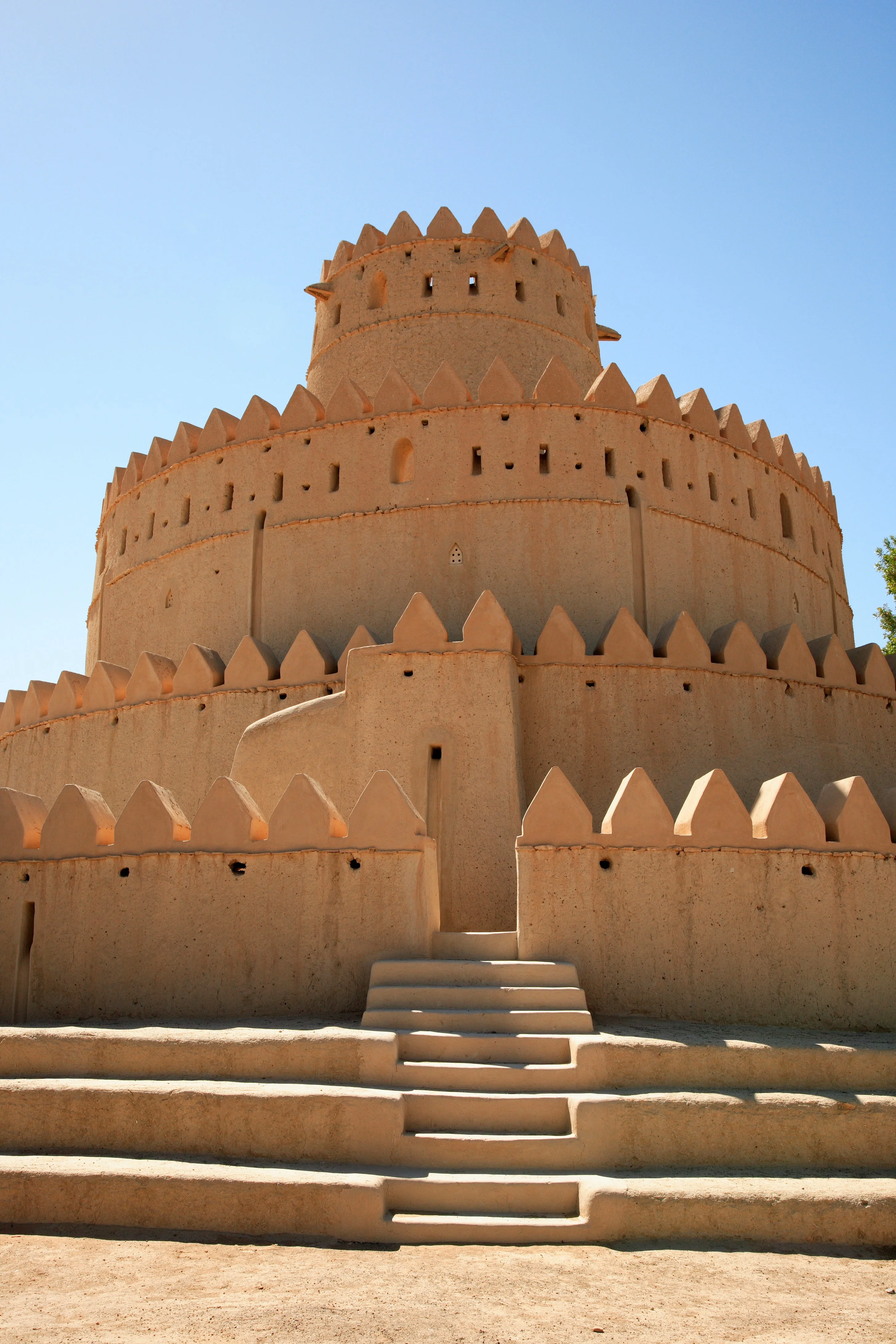 Close-up of Al Jahili Fort's circular tower and desert steps