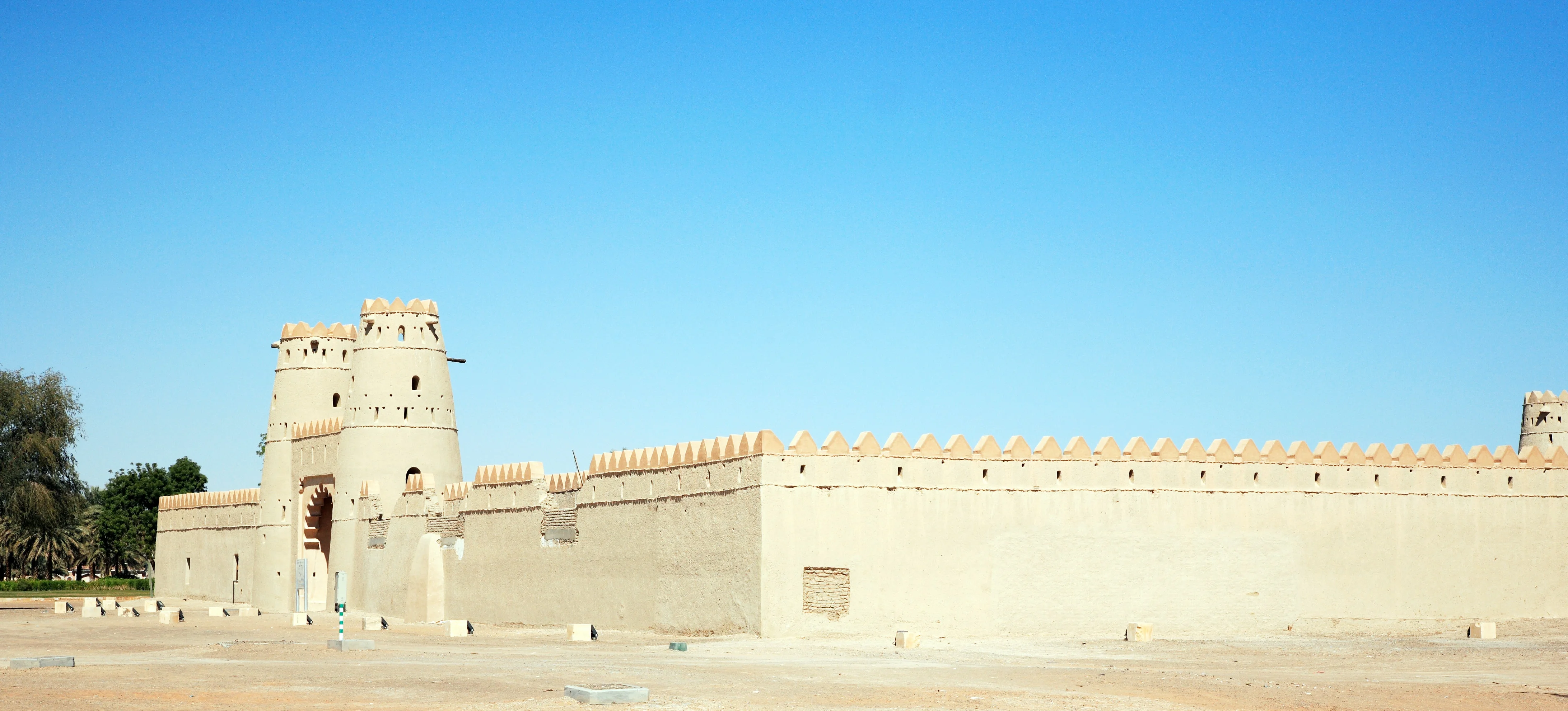 Exterior of Al Ain Fort with sand-colored walls and defensive towers