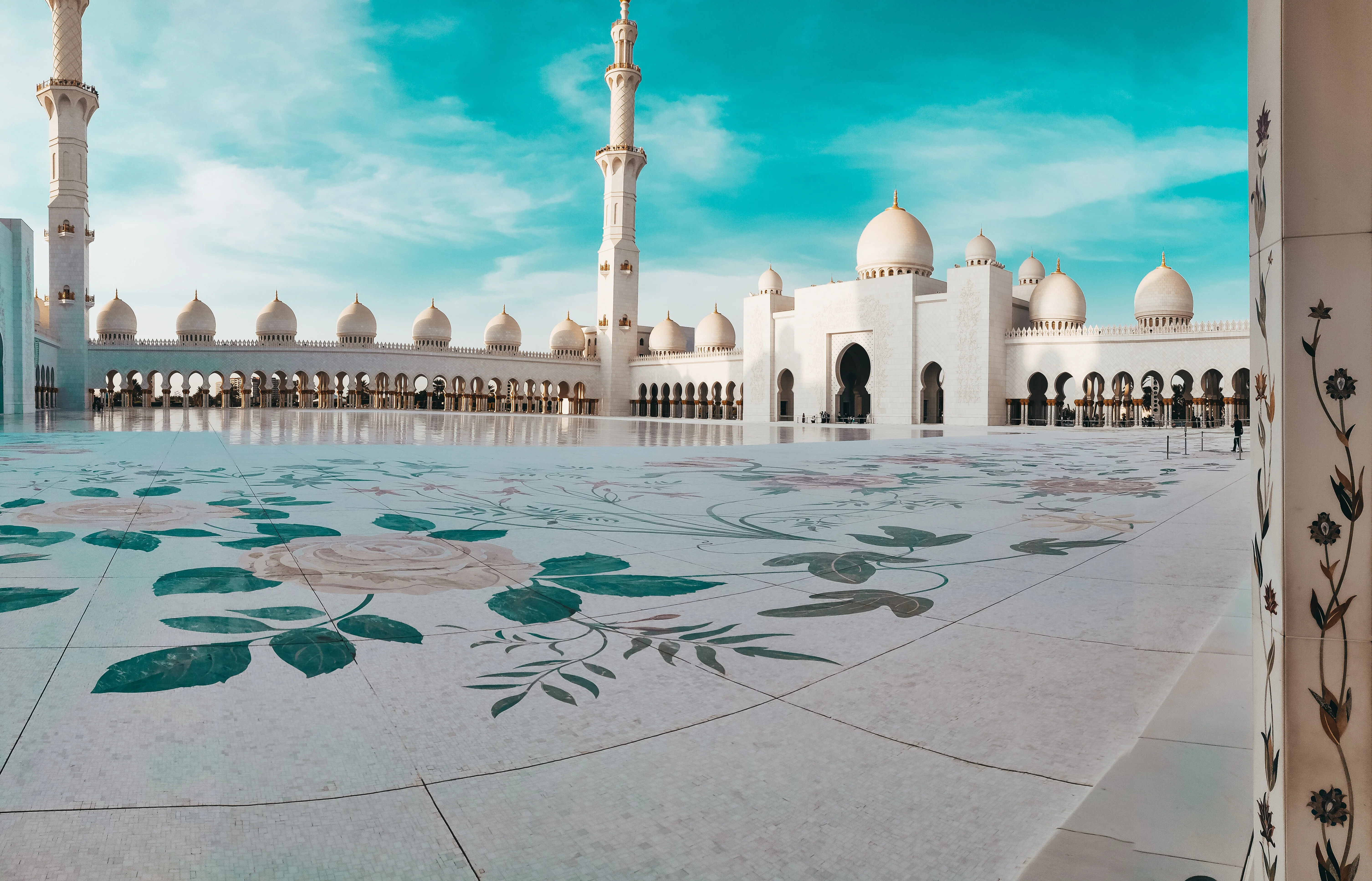 Courtyard view of Sheikh Zayed Grand Mosque with floral tile