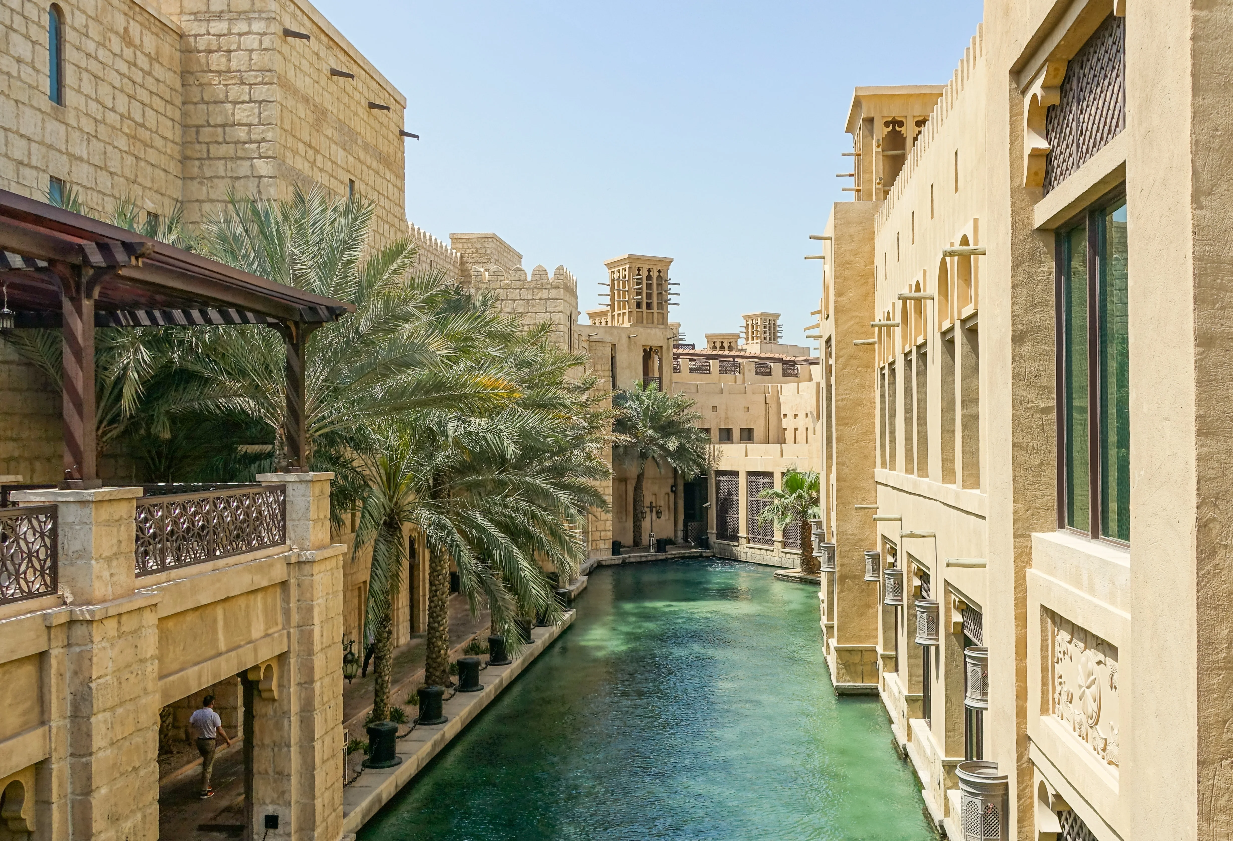 Water canal at Madinat Jumeirah with palm trees and wind towers