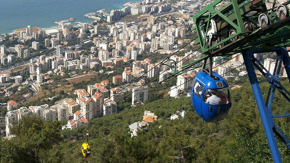 Cable cars of Teleferique overlooking the coastal city of Jounieh and the Mediterranean Sea.