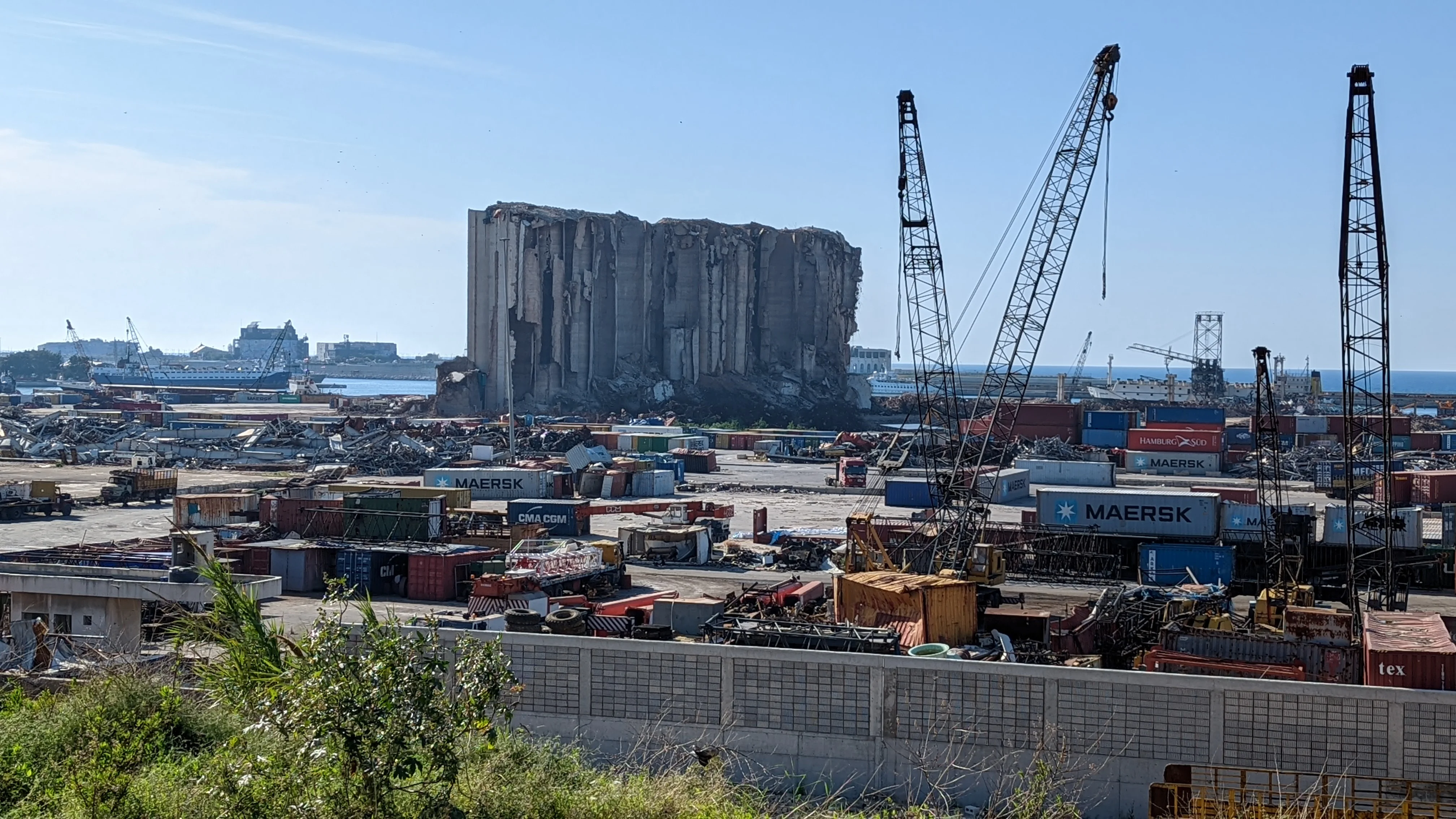Beirut port with damaged grain silos and cranes visible after the 2020 explosion.