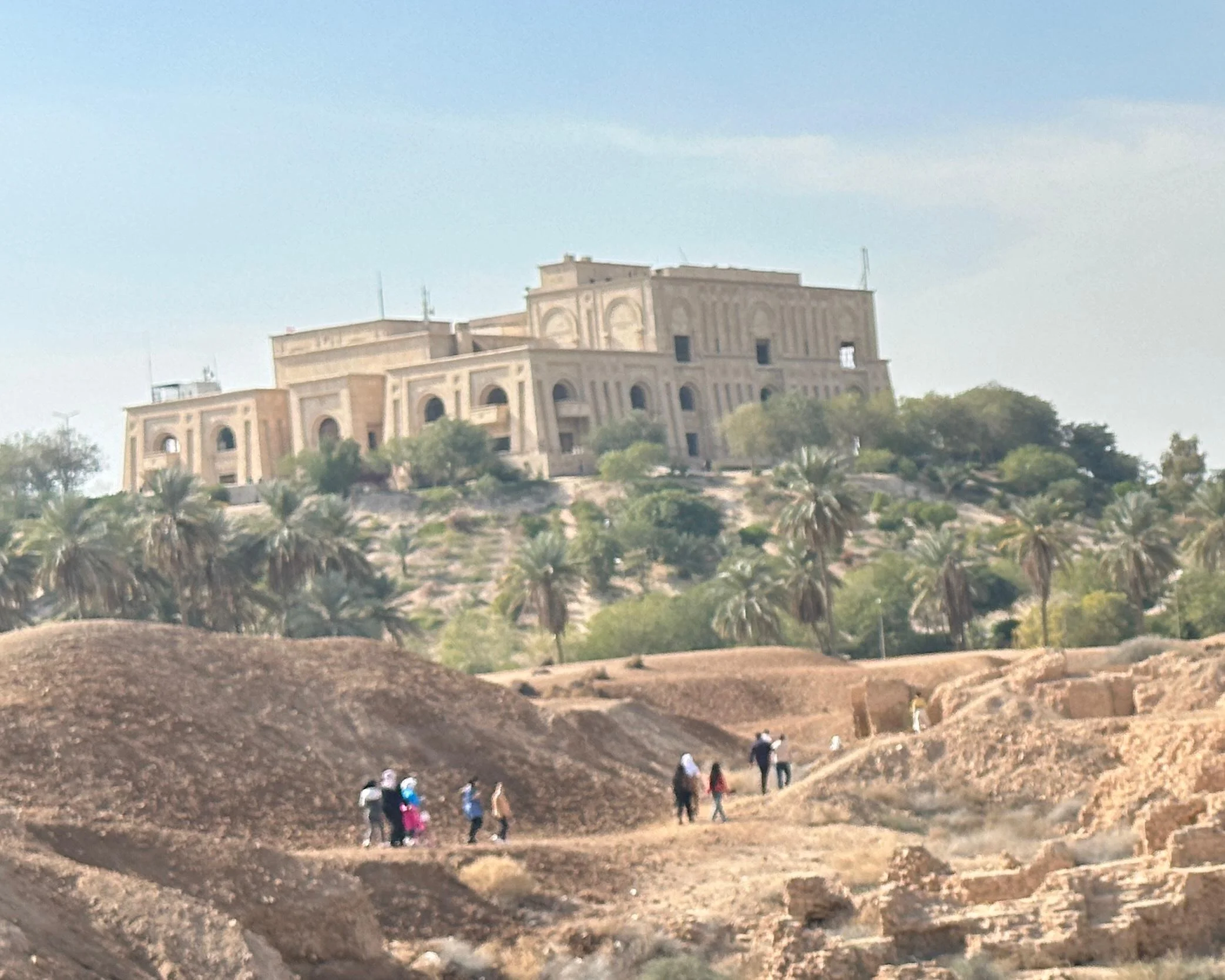 Saddam Hussein’s former palace overlooking the ancient ruins of Babylon and surrounded by palm trees