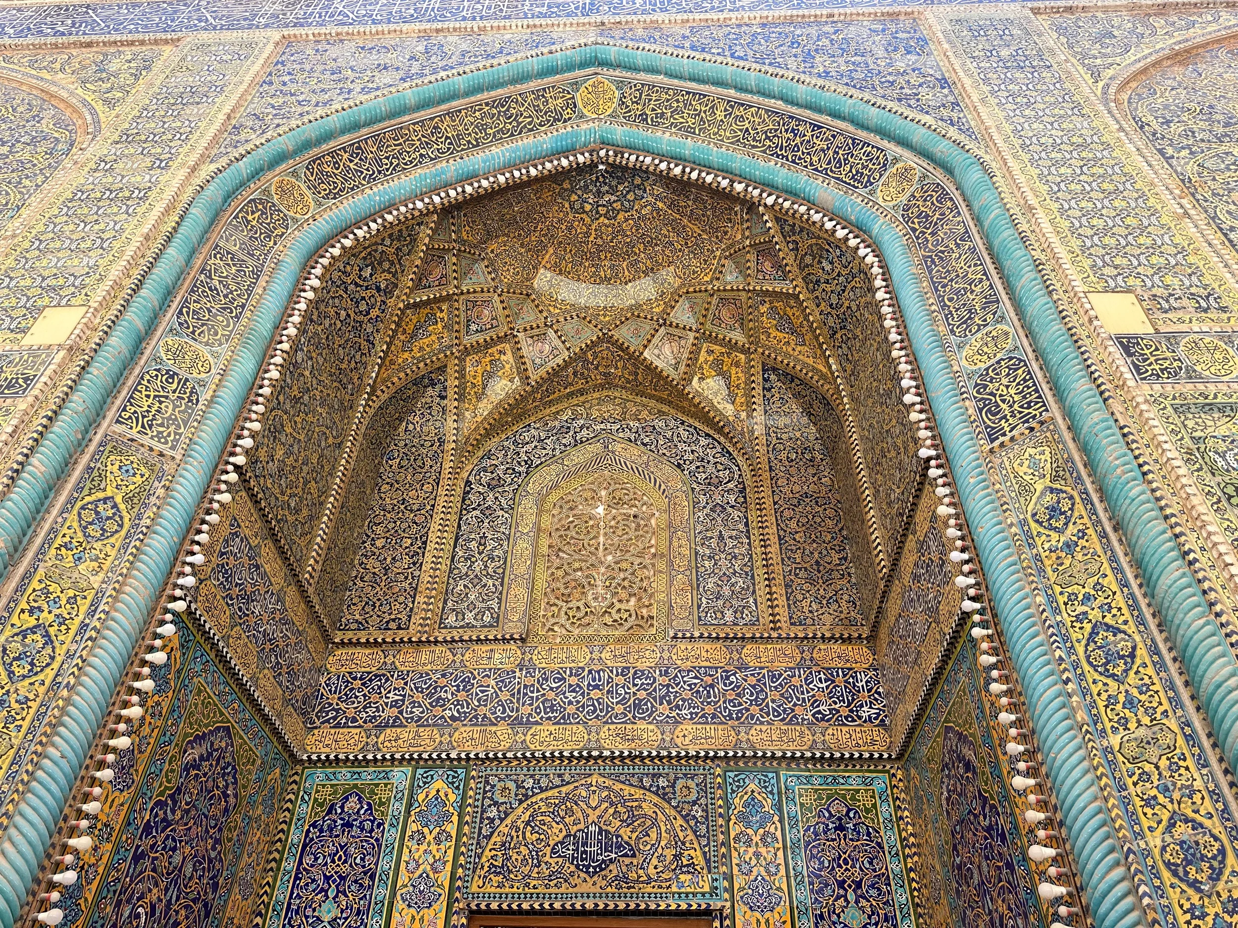 lose-up of intricate Islamic tilework and calligraphy on mosque archway in Iraq’s religious site
