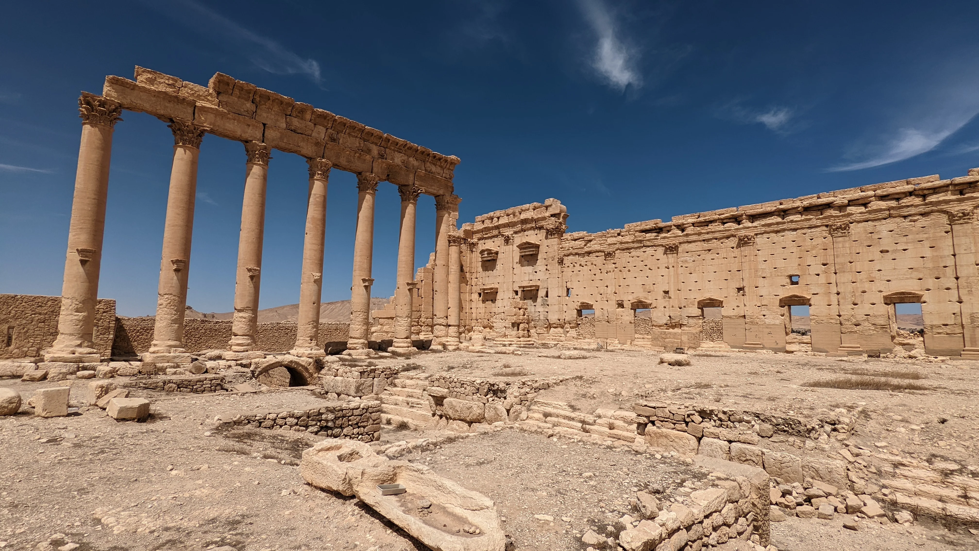 Ruins of Temple of Bel in Palmyra with tall Roman columns and ancient stone structures
