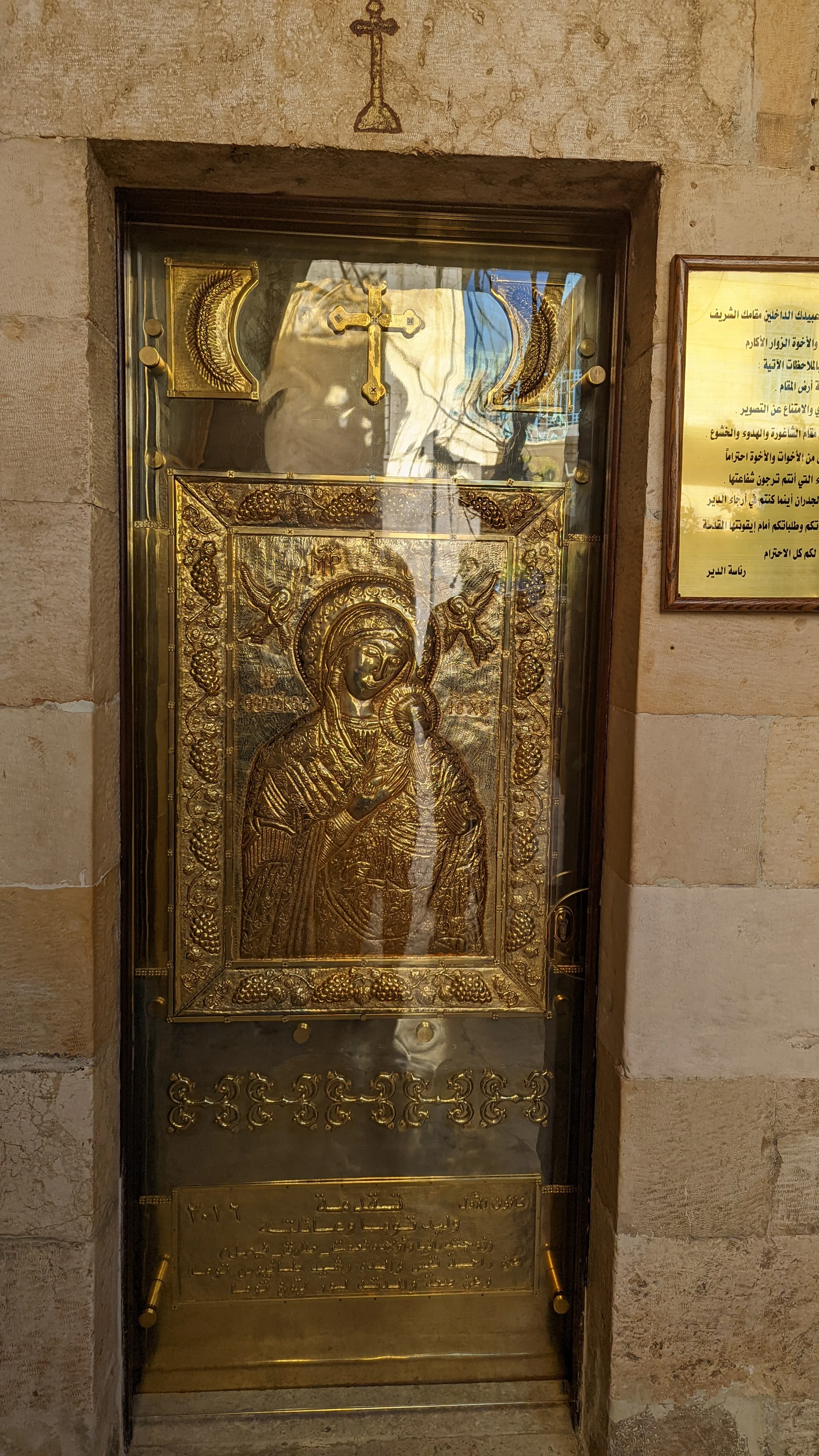 Golden icon of Virgin Mary and child with Arabic text on display inside Maaloula monastery
