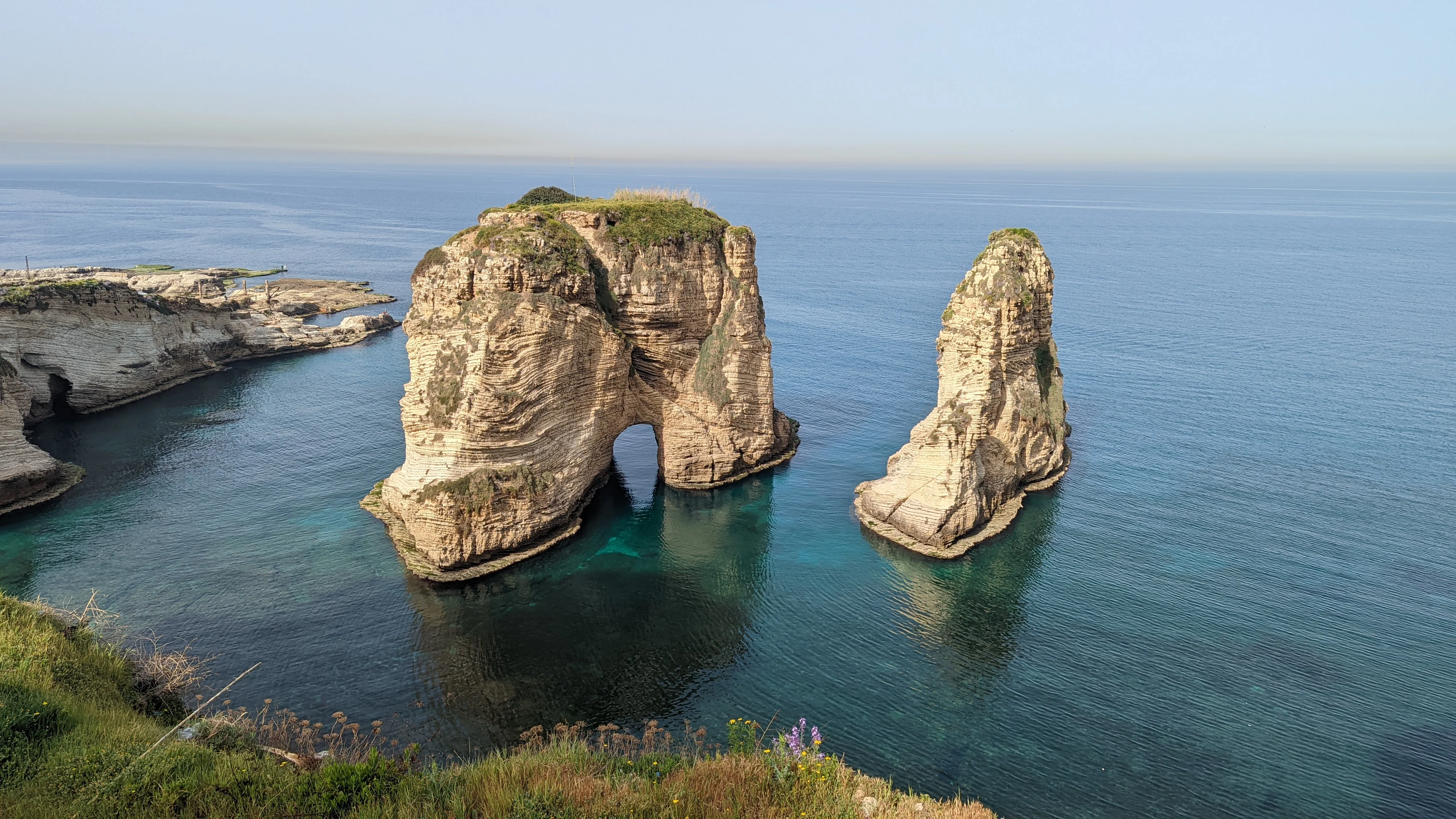 Iconic Pigeon Rocks rising from the blue waters off the coast of Beirut in Raouché.