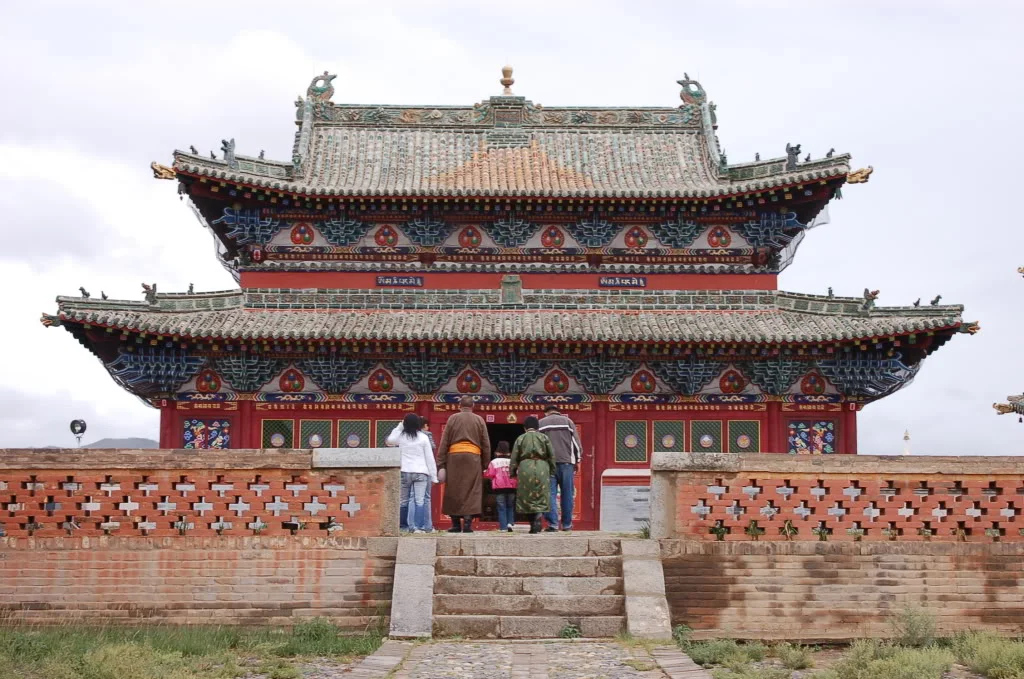 Erdenezuu Temple Mongolia, people entering colorful ornate temple with green tiled roof.