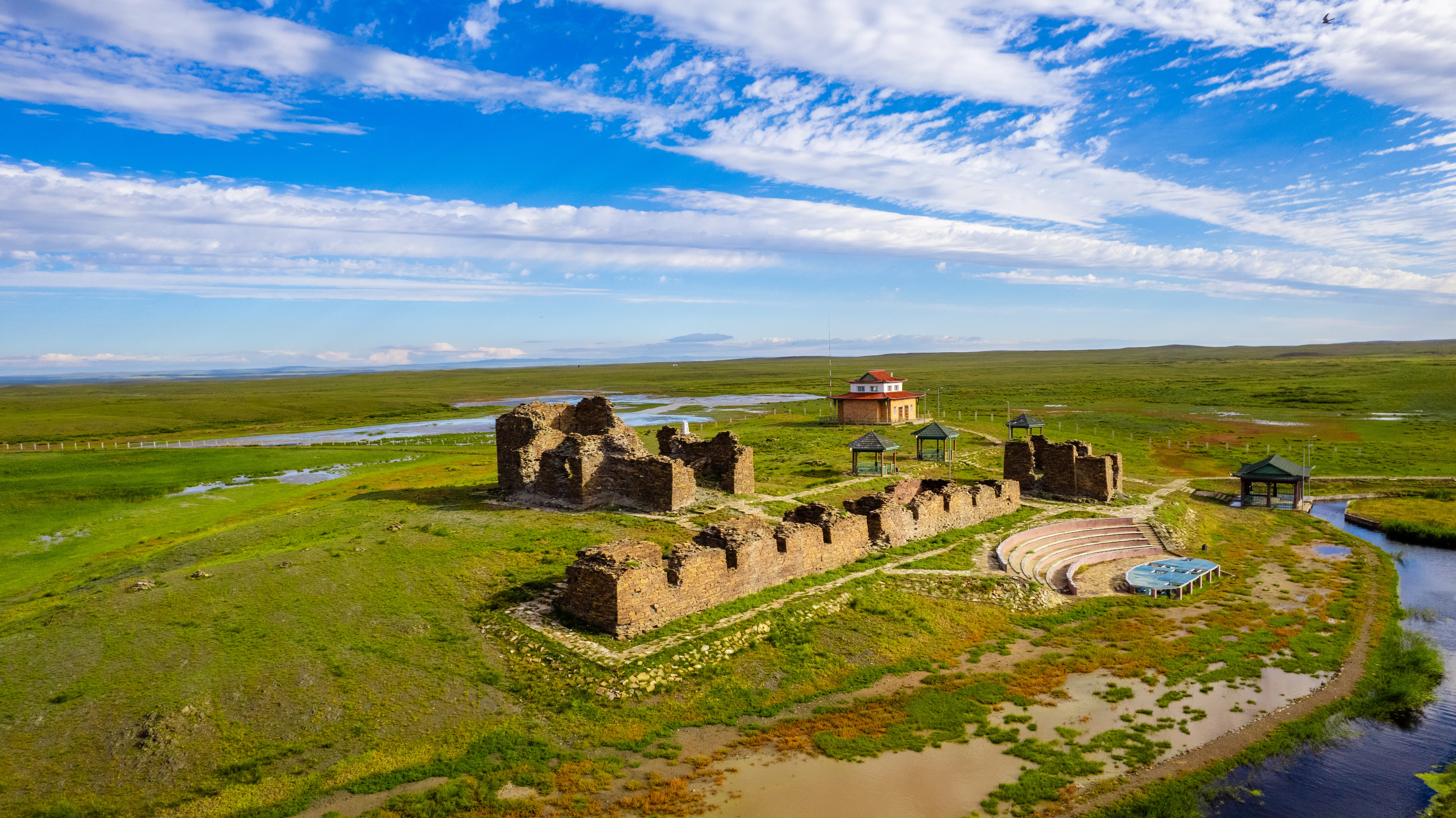 Ruins of Ongiin Khiid Monastery with steppe landscape and river in Mongolia.