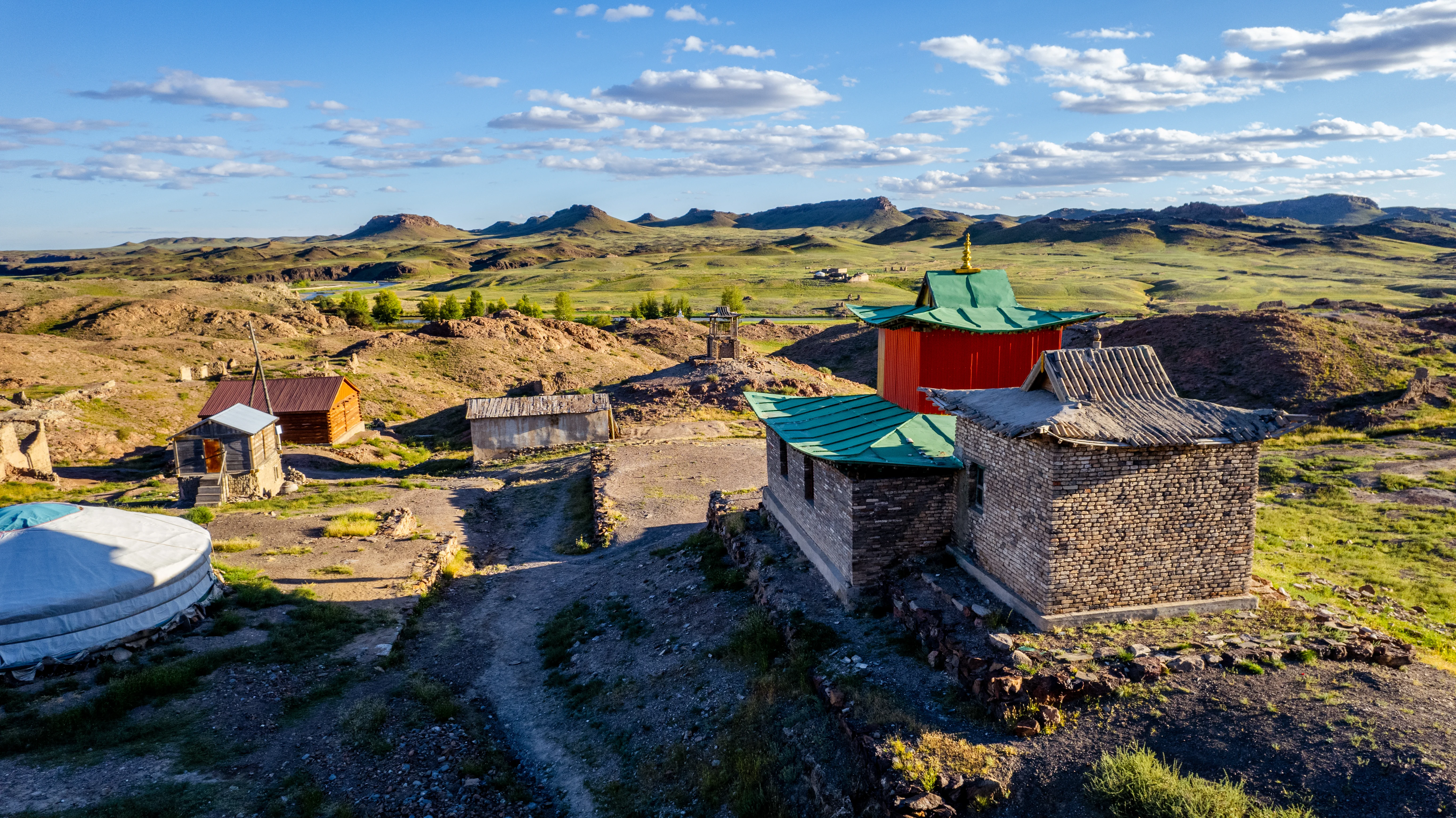 View over Karakorum temple roofs with Mongolia's green hills beyond.