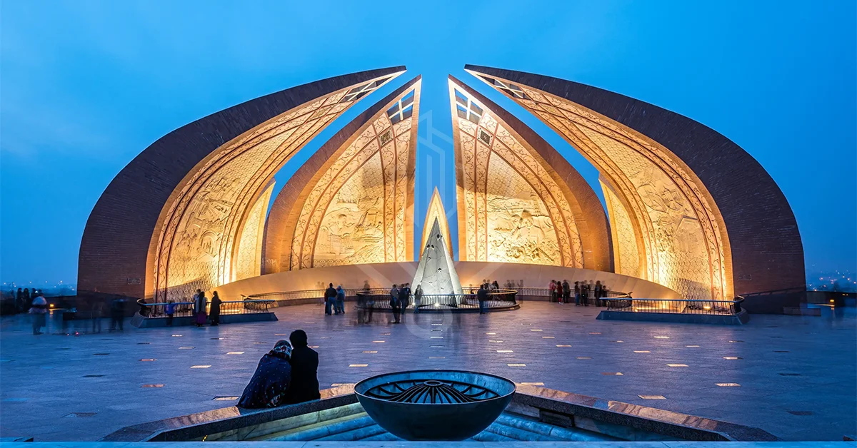 Illuminated Pakistan Monument in Islamabad at dusk with blooming petal-like structures