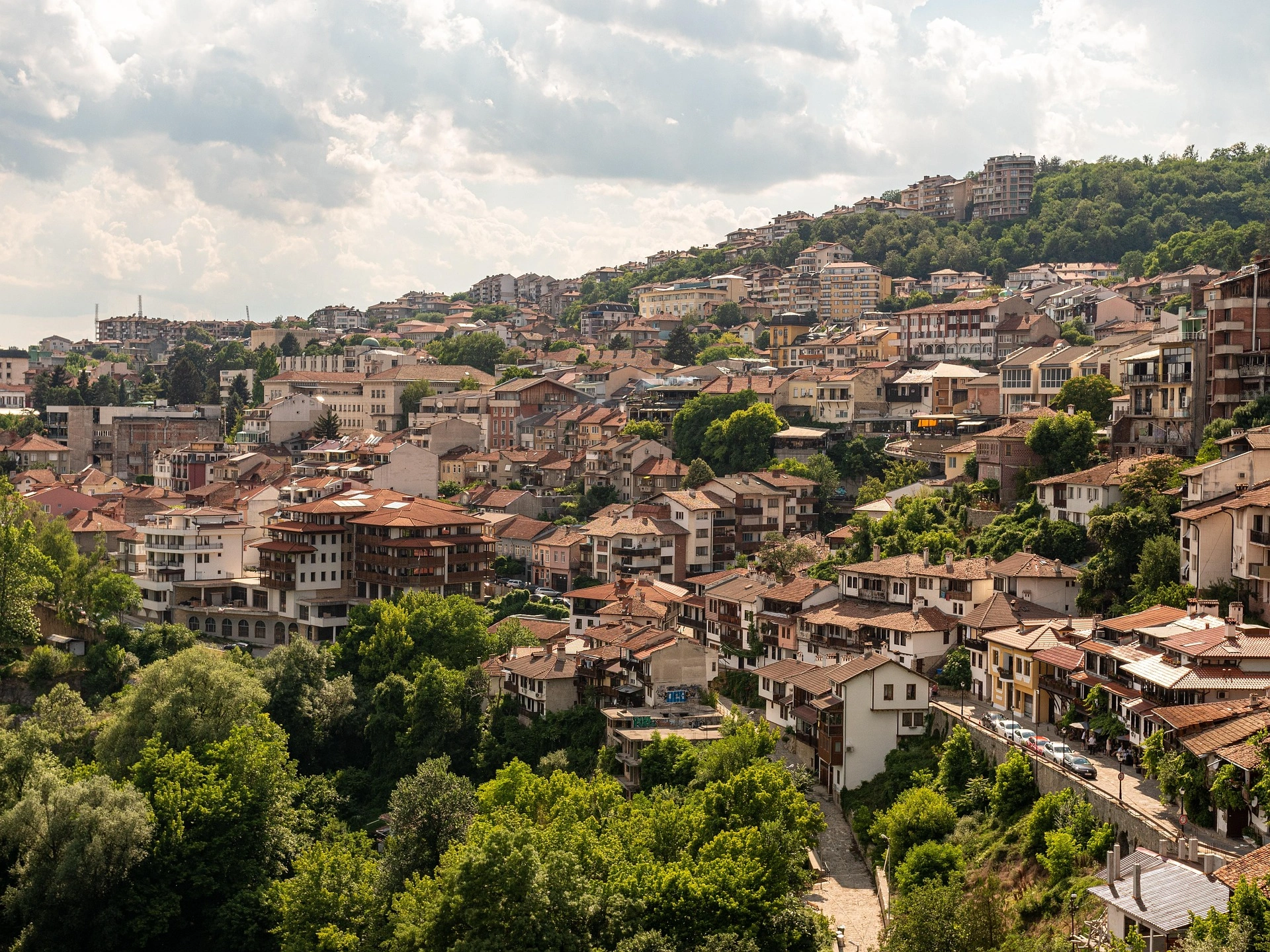 Overlooking Veliko Tarnovo, Bulgaria with clustered houses on green hillsides.