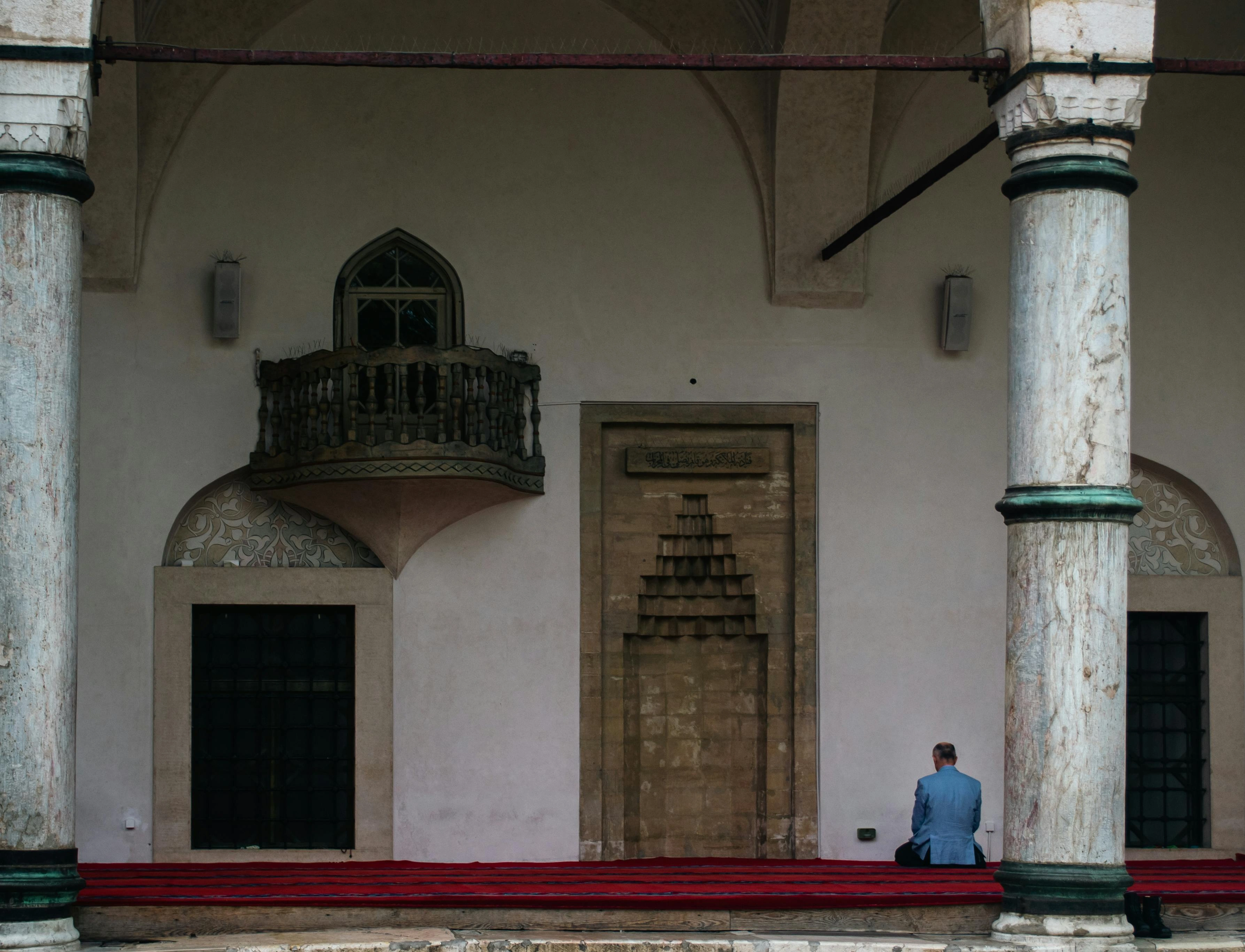 Man praying inside the historic Gazi Husrev-beg Mosque in Sarajevo, Bosnia and Herzegovina.