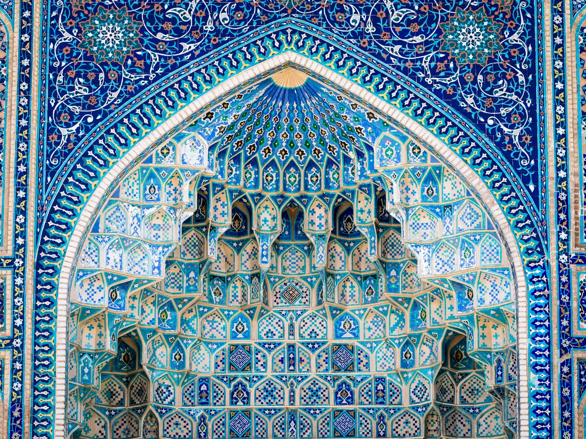 Close-up of intricate blue tilework and geometric patterns at the Gur-e Amir Mausoleum, final resting place of Tamerlane, in Samarkand, Uzbekistan.